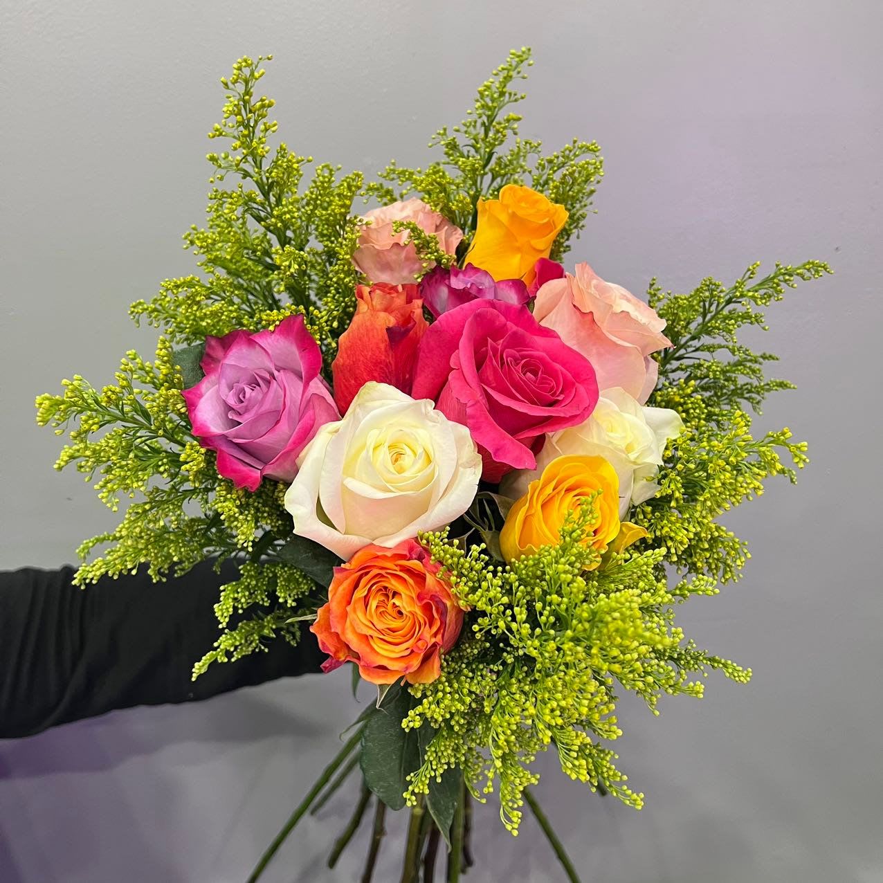 One Dozen Mix Color Rose Bouquet - A vivid mix of hot pink, citrus orange, creamy white, and sunshine yellow blooms, “One Dozen Mix Color Rose Bouquet” is your go-to bouquet for instant cheer. Wrapped in playful textures and vibrant greens, it’s perfect for sweet gestures, spontaneous celebrations, or adding a little sparkle to the everyday.  For the color lover, the party starter, and the unapologetically joyful.