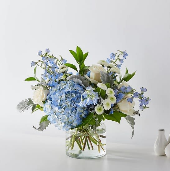 Sea Shades Bouquet - With powdery blue hydrangeas, soft white roses, and delicate field blooms, “Sea Shades” captures the quiet rhythm of the sea. Gentle, airy, and thoughtfully arranged, it’s perfect for expressing calm affection, peaceful support, or simply bringing a breath of coastal elegance into any room.  For moments of reflection, soft celebrations, or just-because serenity.