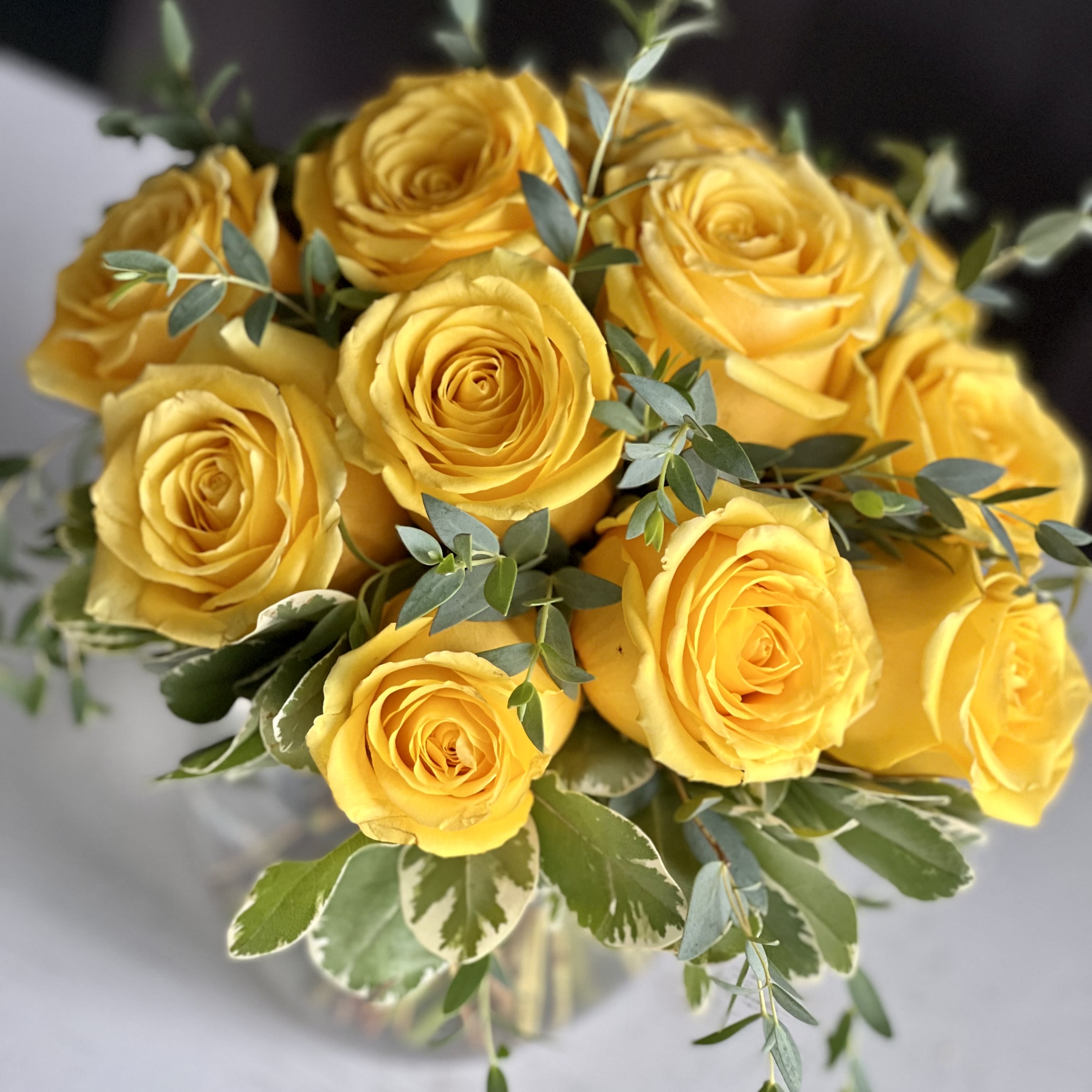 Modern Dozen Yellow - 12 premium yellow roses in a low and lush style! Perfect for any occasion, this is a modern take on a traditional design; not your typical 'long stem style.'  Pictured vase is 6.5&quot; tall.  Also available in: white, orange, and peach. If you would like a color other than yellow, please specify the desired color in the special instructions box during check out. Vase may vary.
