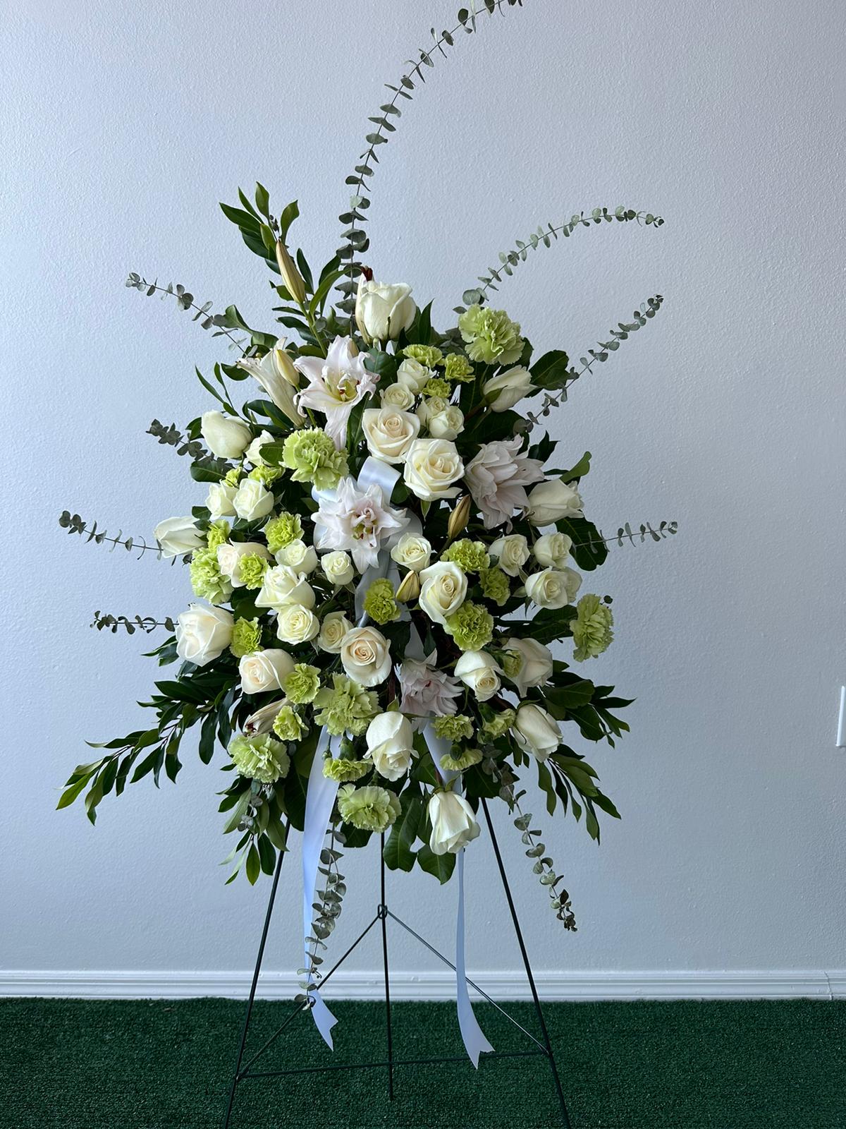 White serenity standing spray White serenity standing spray - "Picture is a reference every arrangement would not be exactly the same. Flowers and color substitution may apply"