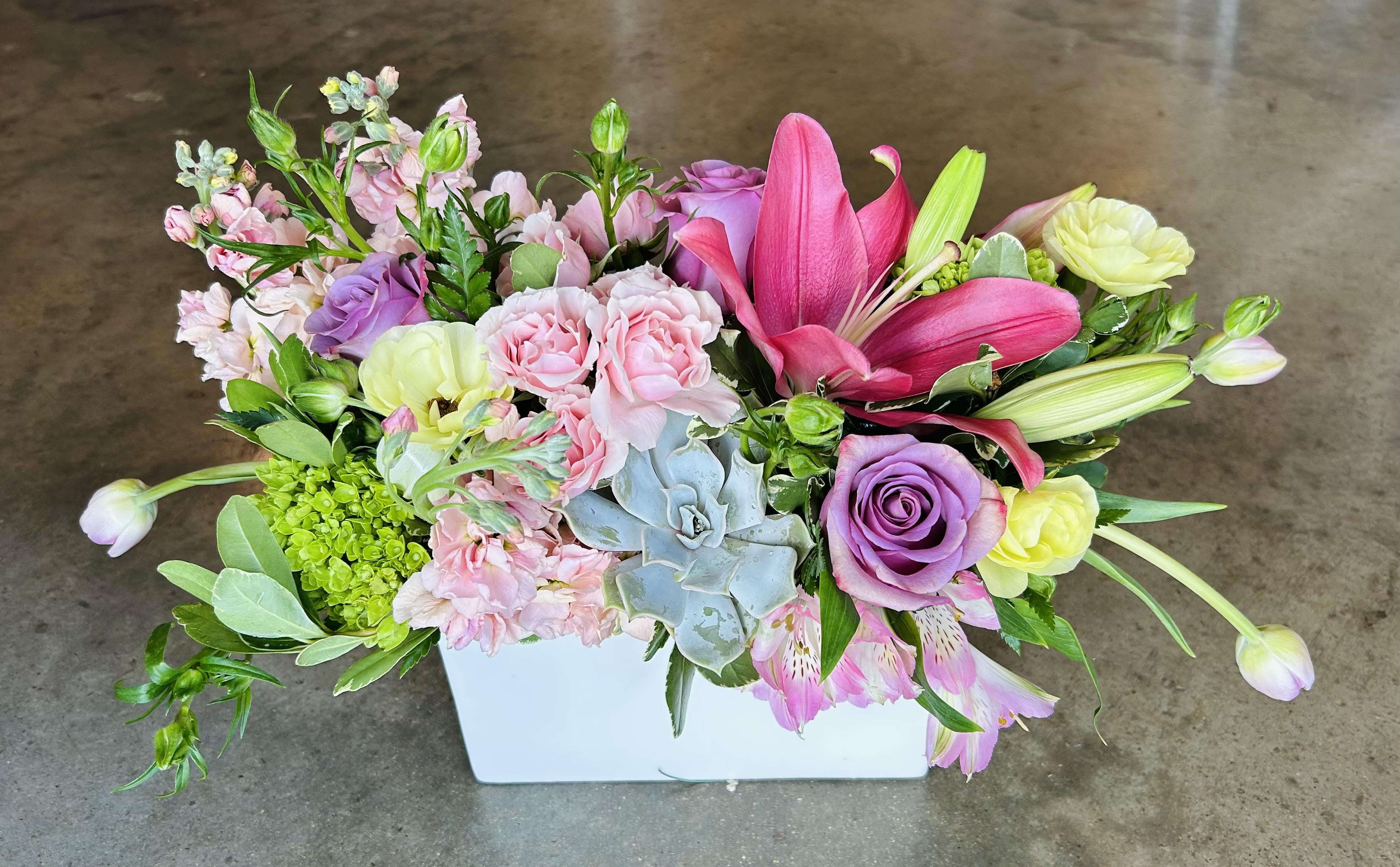 Boxie Boxie - pink spray roses, lavender roses, green hydrangea, lisianthus, pink lily in a box with a succulent