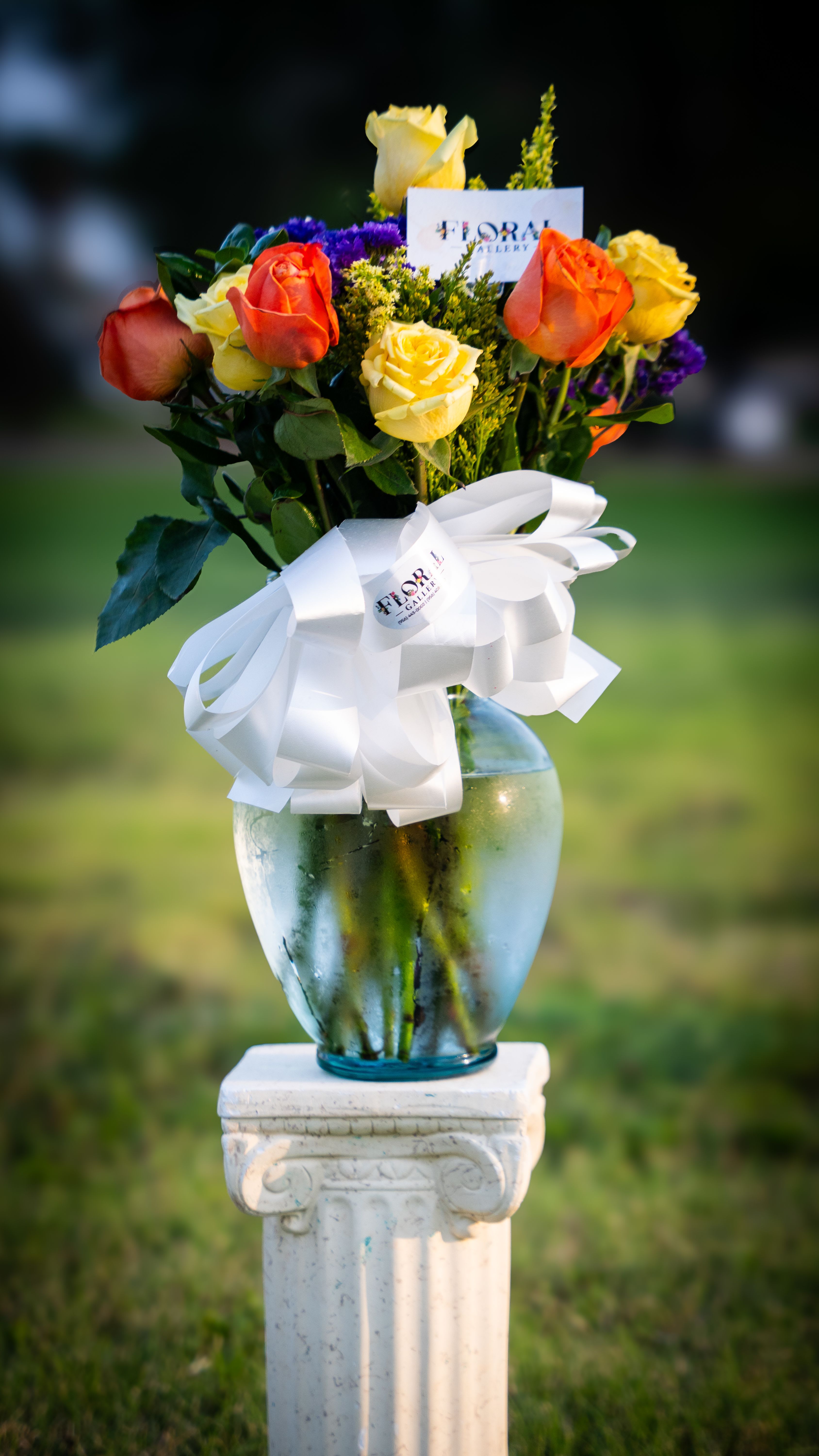 Sunset Sonata Sunset Sonata - A radiant composition of glowing orange and yellow roses paired with charming purple daisies, creatina symphony of warmth and joy. This stunning arrangement captures the beauty of a golden sunset melting into twilight- perfect for celebrating life's vibrant moments, expressing heartfelt gratitude, or simply brightening someone's day.