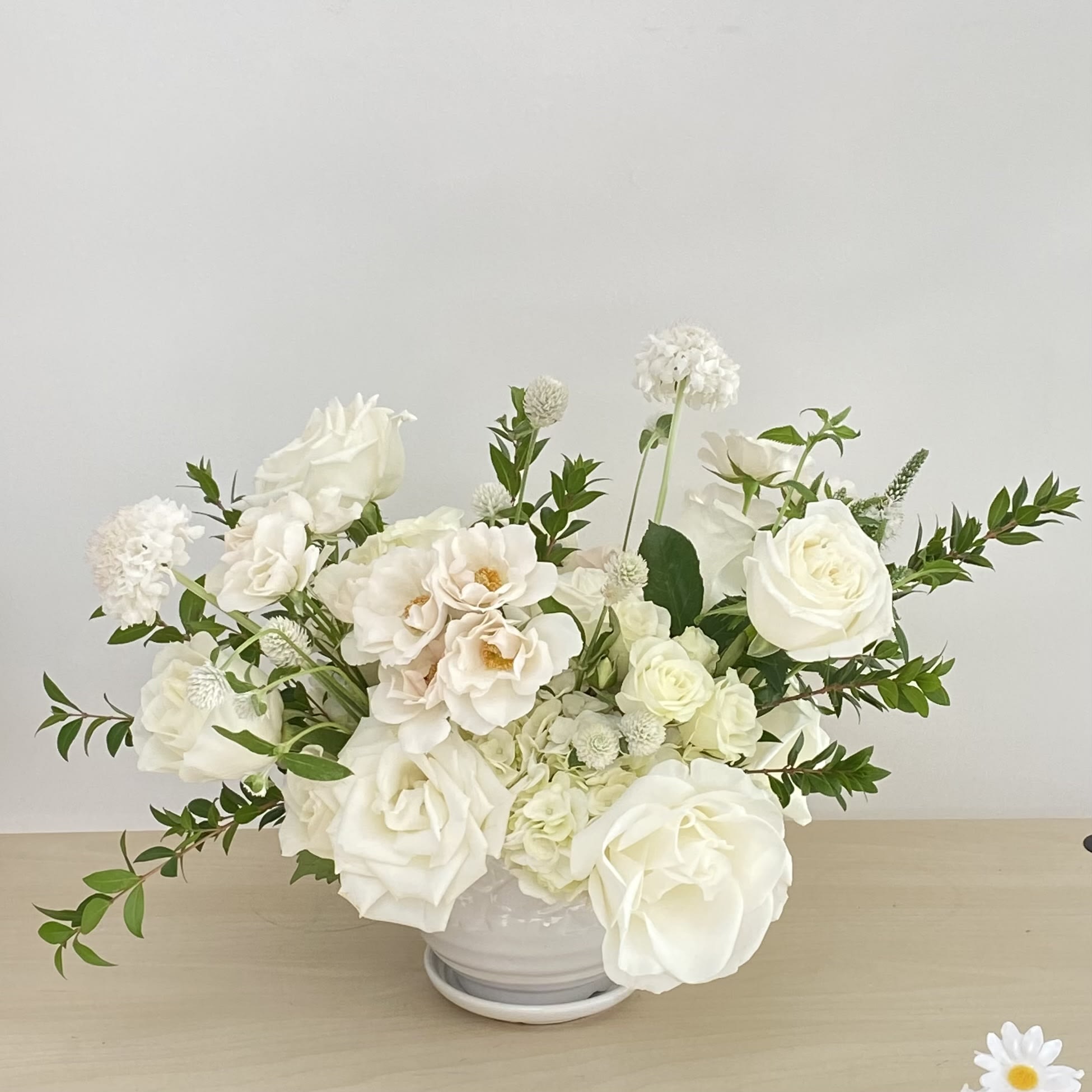 Bright in White Bright in White - A white low vase filled with elegant all-white flowers. Flower types may vary depending on the season.