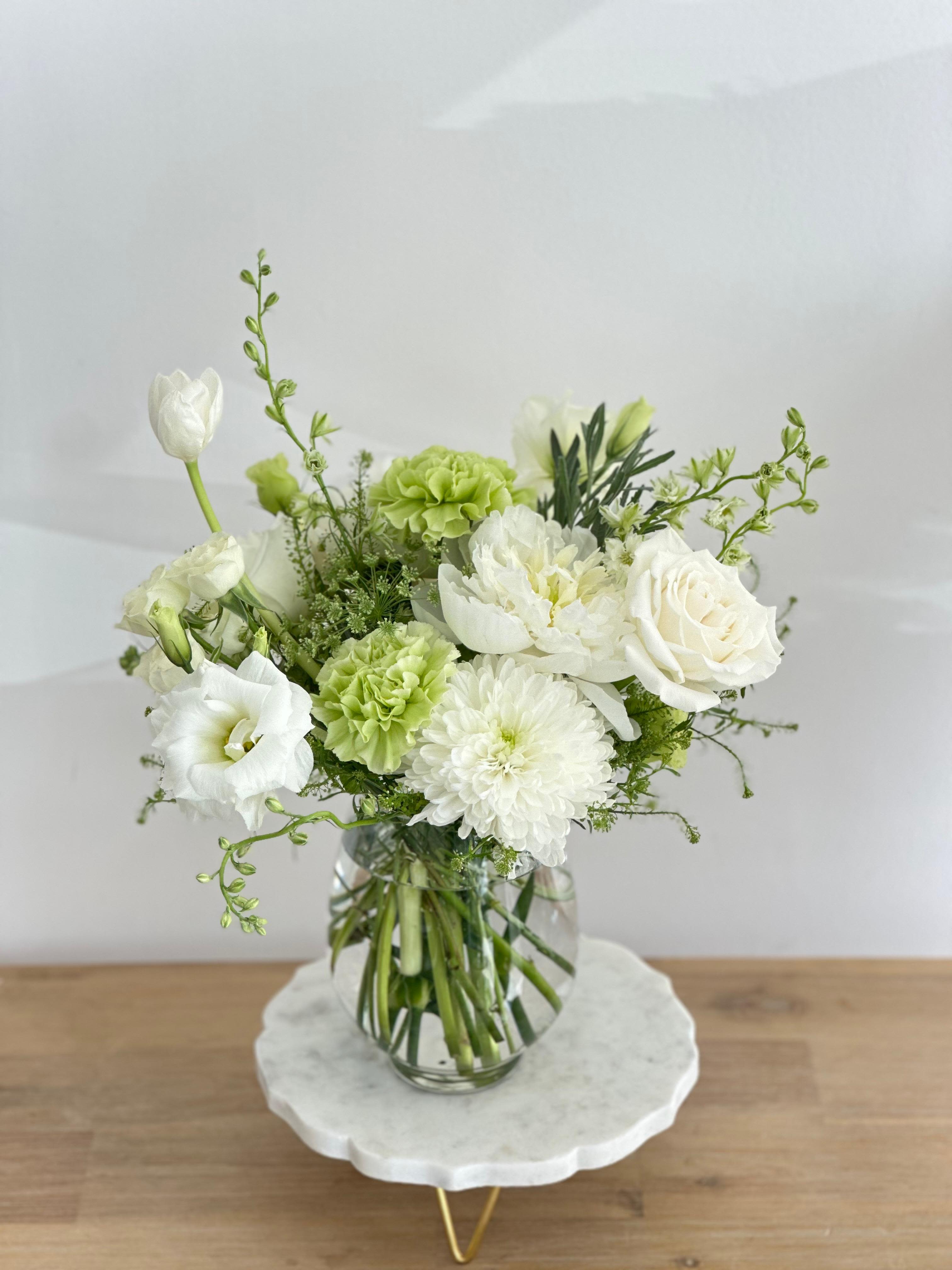 Green Goddess Green Goddess - An egg-shaped glass vase with white and green flowers. Flower types may vary depending on the season.