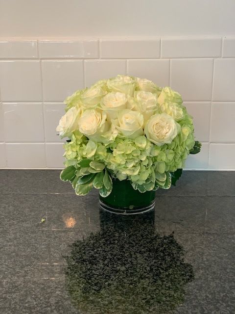 Cooper's Beach Designer's Choice  - Cooper's Beach Designer's Choice is our #1 Selling Item. Flowers are essential for any event regardless of the occasion. We customize each arrangement with the highest flower quality geared towards any special moment.   Standard starts at $150 with 12 white roses  Deluxe starts at $175 with 18 white roses  Premium starts at $225 with 24 white roses   This floral design is arranged in a glass vase with color tones of all white flowers to include white hydrangeas, white roses, white lisanthus, white hyacinth and accents of succulents. 