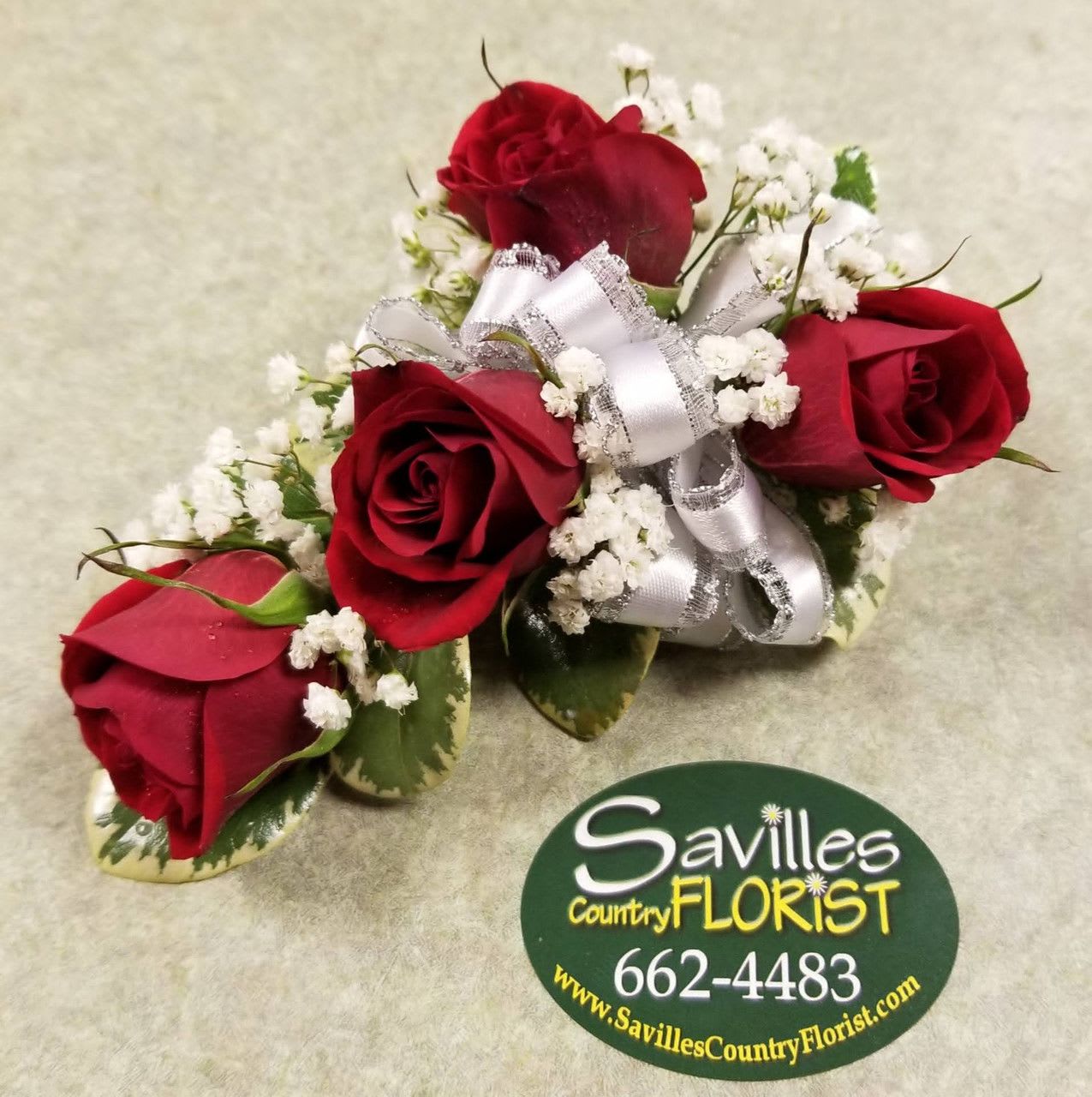 Corsage 4 Red spray Roses Corsage 4 Red spray Roses - Wrist corsage with 4 red spray roses and babies breath, accented with a white / silver bow If you are interested in a different color bow, let us know in the special instructions area at checkout.