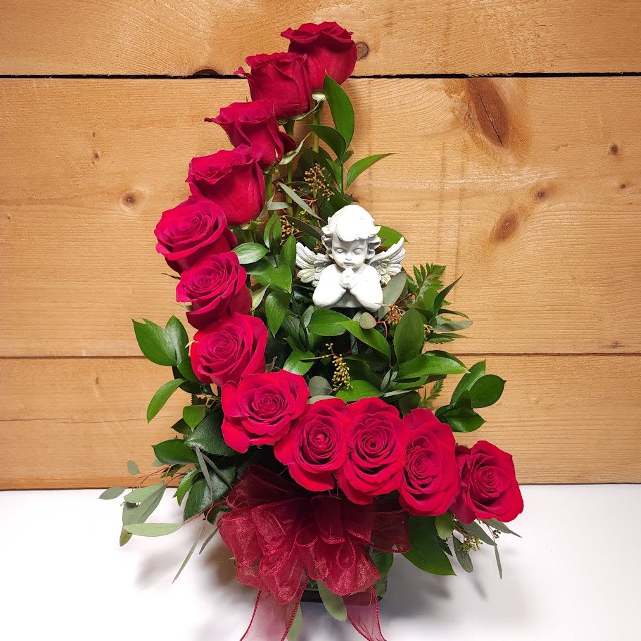 Stairway to Heaven Stairway to Heaven - For a different take on the typical one dozen roses, The Stairway to Heaven by Savilles Country Florist is a stunning spiral presentation of one dozen premium red roses skillfully displayed in a aspidistra leaf wrapped glass cylinder and accented with foliage and highlighted with a ceramic angel. Suitable for most occasions.