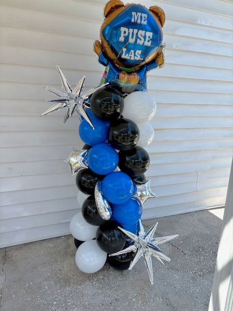 Graduation Balloon Column - a tower of blue, black and white balloons topped with a Ballon the reads &quot;Me Puse Las Pilas&quot; (Spanish for batteries charged) Great graduation gift or beautiful addition to your get together. 