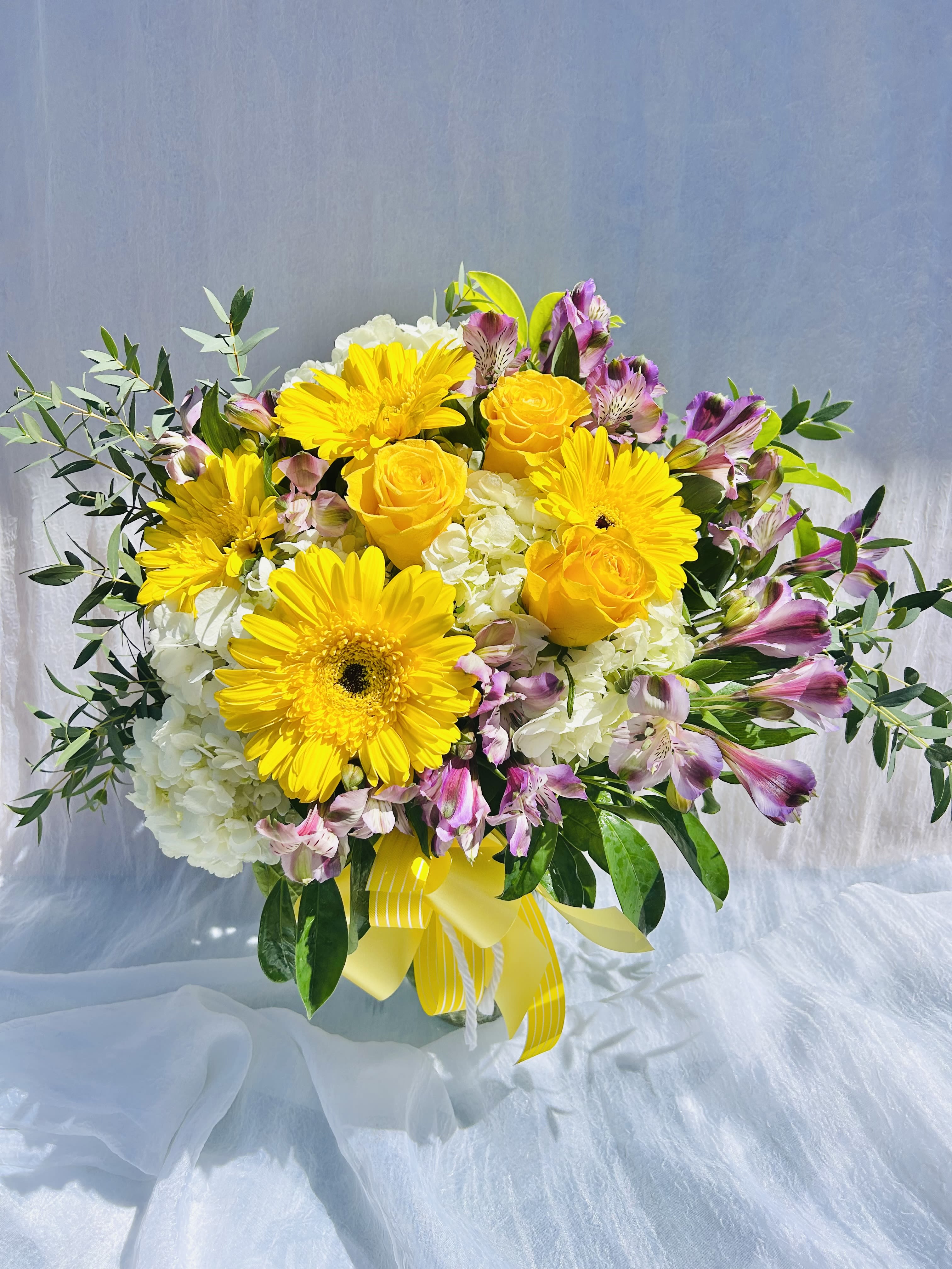 Abundance - Beautiful bouquet featuring  hydrangeas, yellow daises, yellow roses, pink alstroemeria, and green accents