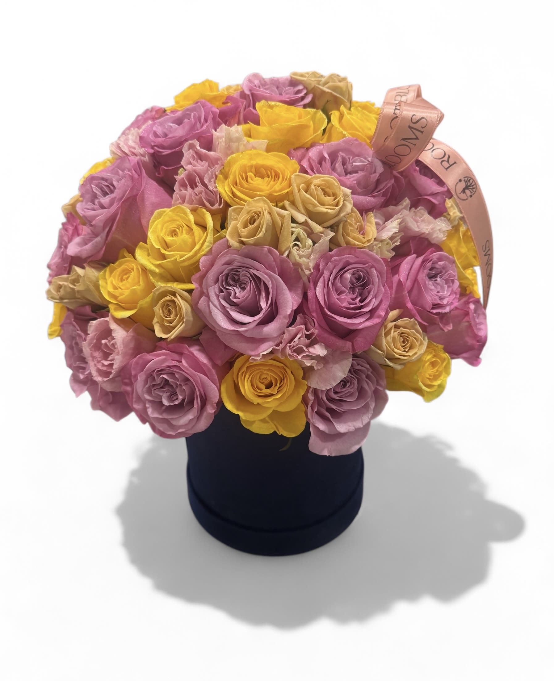 Bloom Box - A vibrant mix of blush pink, golden yellow, and soft beige roses arranged in a luxurious velvet box. This cheerful yet elegant piece is perfect for birthdays, celebrations, or just because. 
