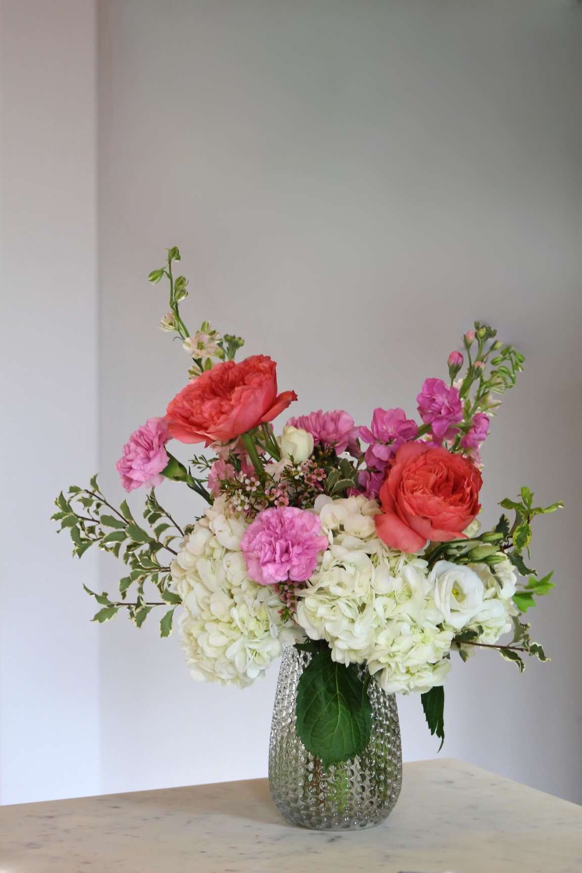 Pretty - Introducing &quot;Pretty&quot; – a delightful floral arrangement that embodies the essence of elegance and beauty.  At the heart of &quot;Pretty&quot; are delicate white hydrangeas, pink garden-like roses,  and fragrant stock. 