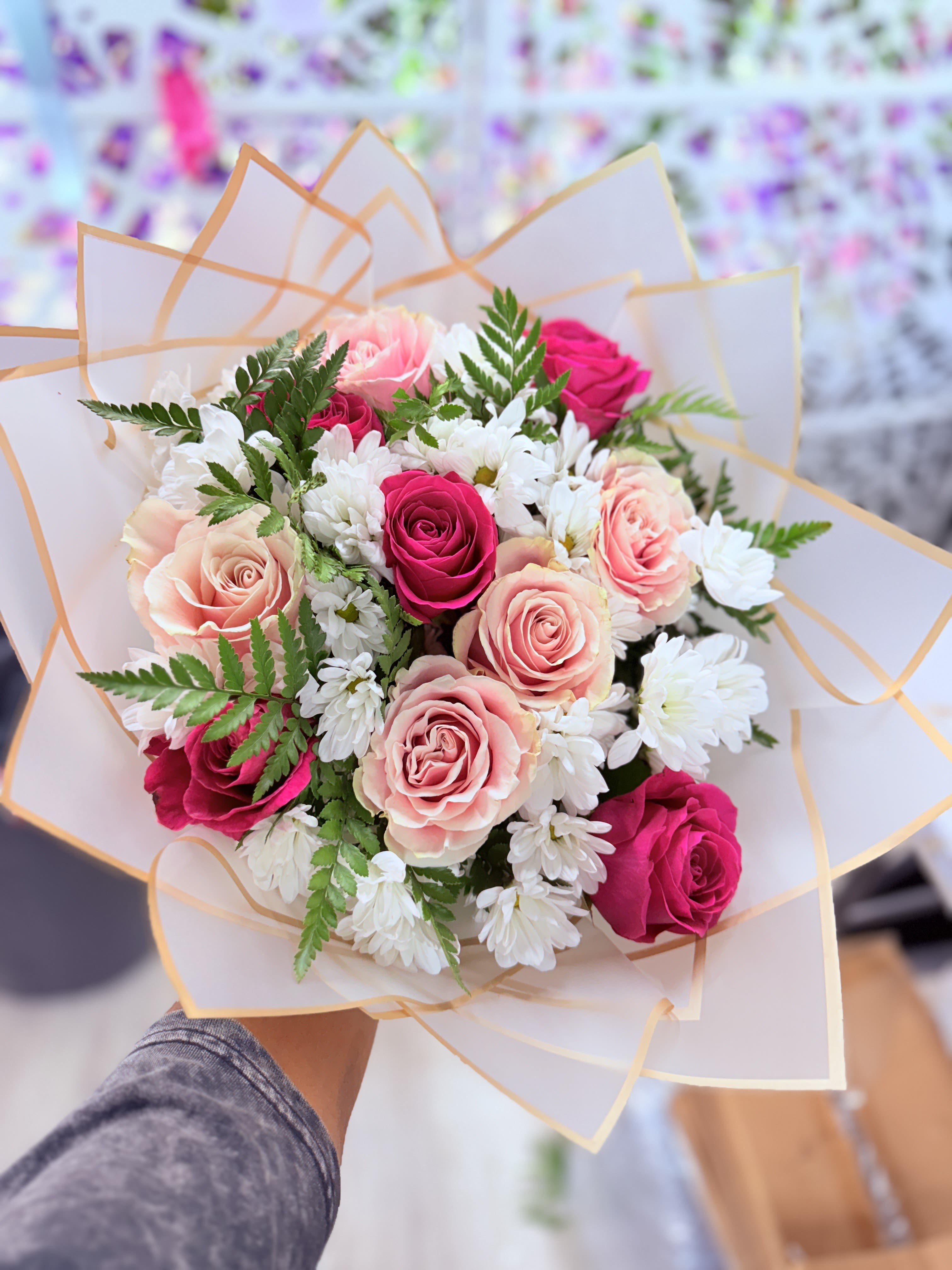 - Bloom Reverie - Bloom Reverie - A graceful symphony of blush roses, snowy chrysanthemums, and delicate pink carnations, hand-tied with care in soft peach wrapping and a satin ribbon. This bouquet whispers sophistication with every petal — ideal for romantic moments, heartfelt gifts, or a touch of everyday luxury. Whether shared to celebrate love or simply brighten a room, it’s a floral expression of beauty and warmth