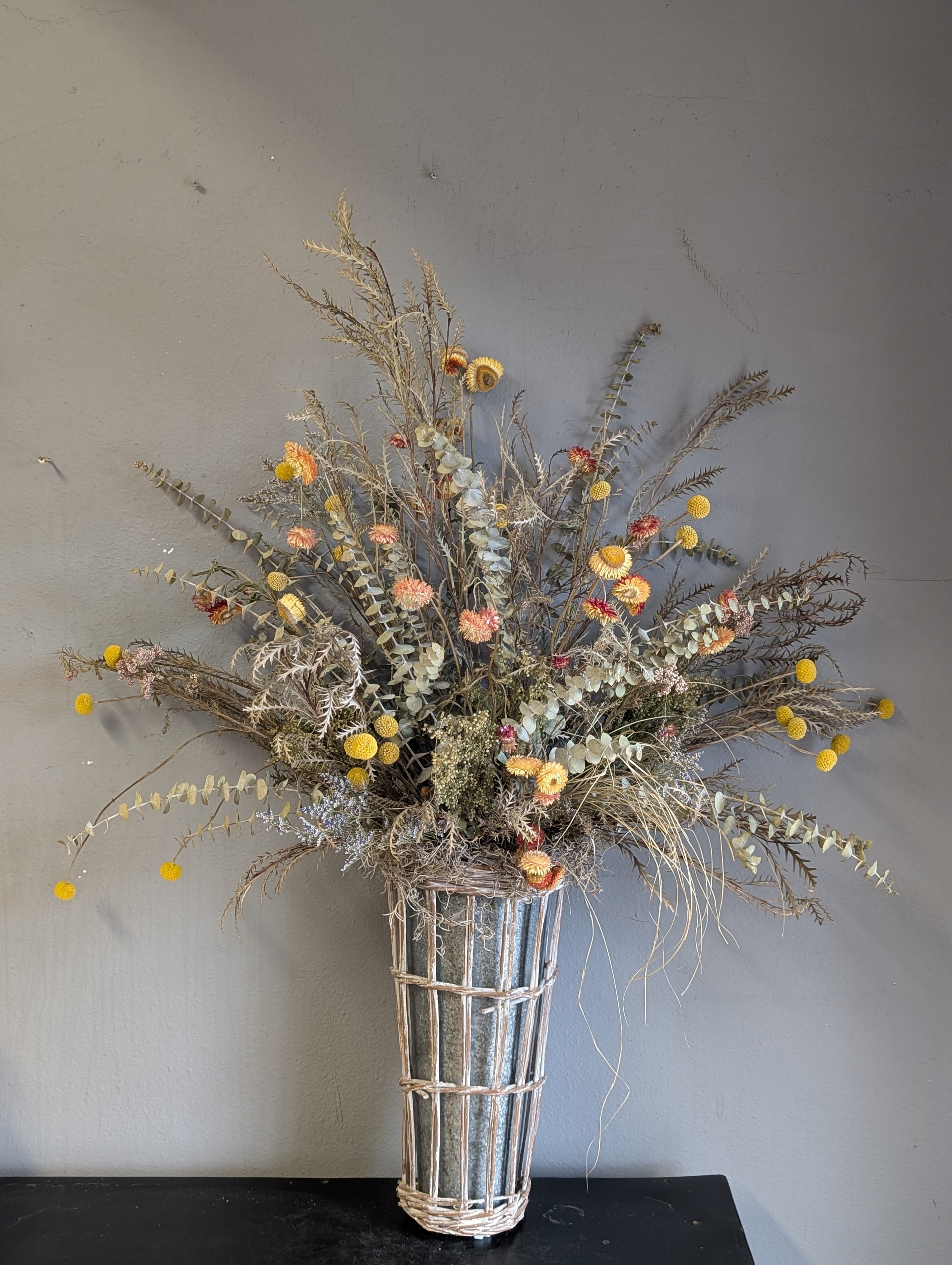 Wild flower wall hanger DRIED FLOWERS - #1 - A beautiful wildflower mix of yellow and neutral colored. This dried flower arrangement is in a galvanized tin/ basket to be hung on a wall in the home or office. No watter needed, long lasting and fun! 