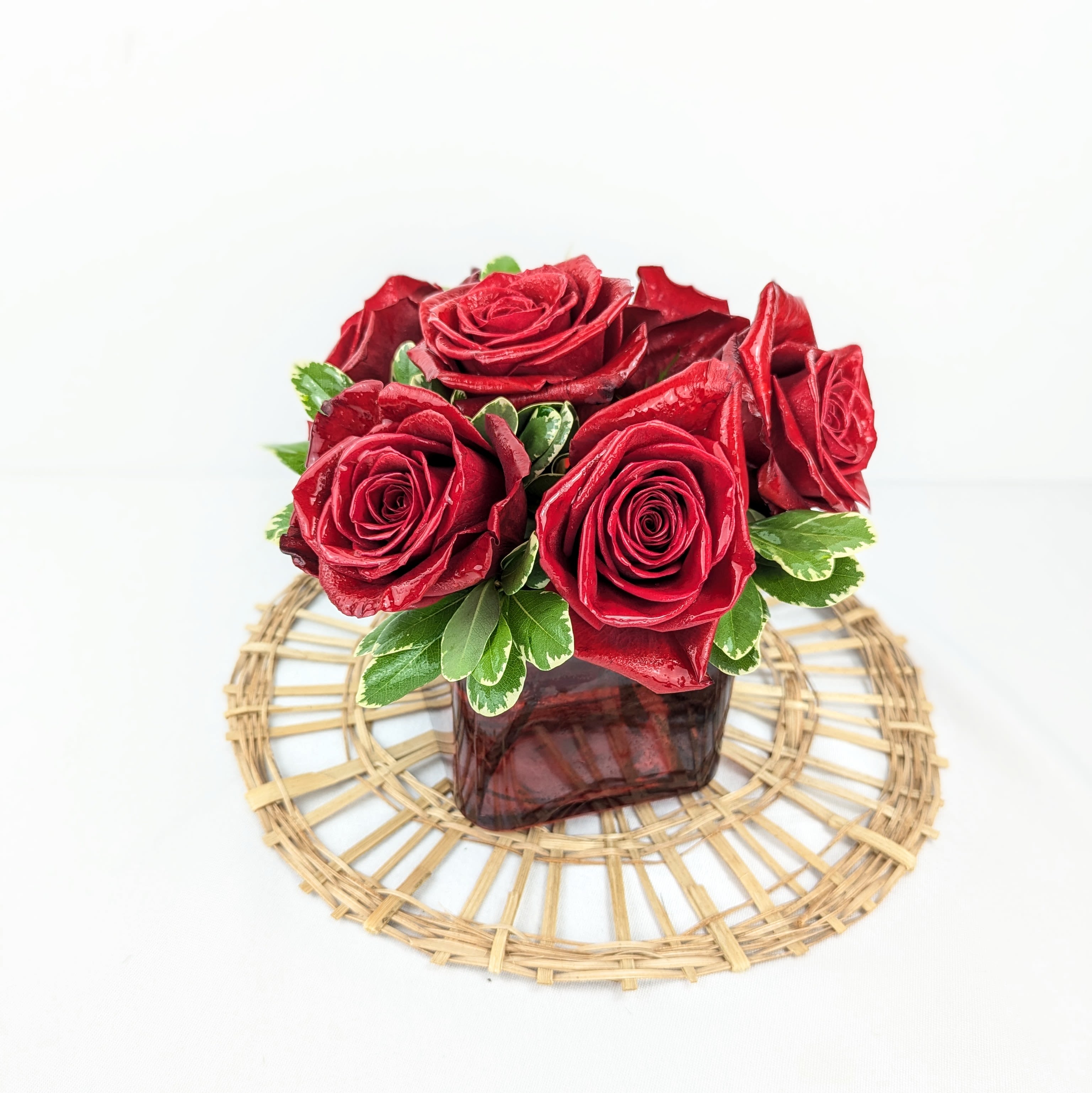 Radiant in Red - This bold yet tasteful bouquet is the perfect size for any desk. Radiant in Red makes a great gift for Valentine's Day, a Birthday, or an Anniversary.  Arrangement Details: Red Roses in a Red, Cubed Vase 