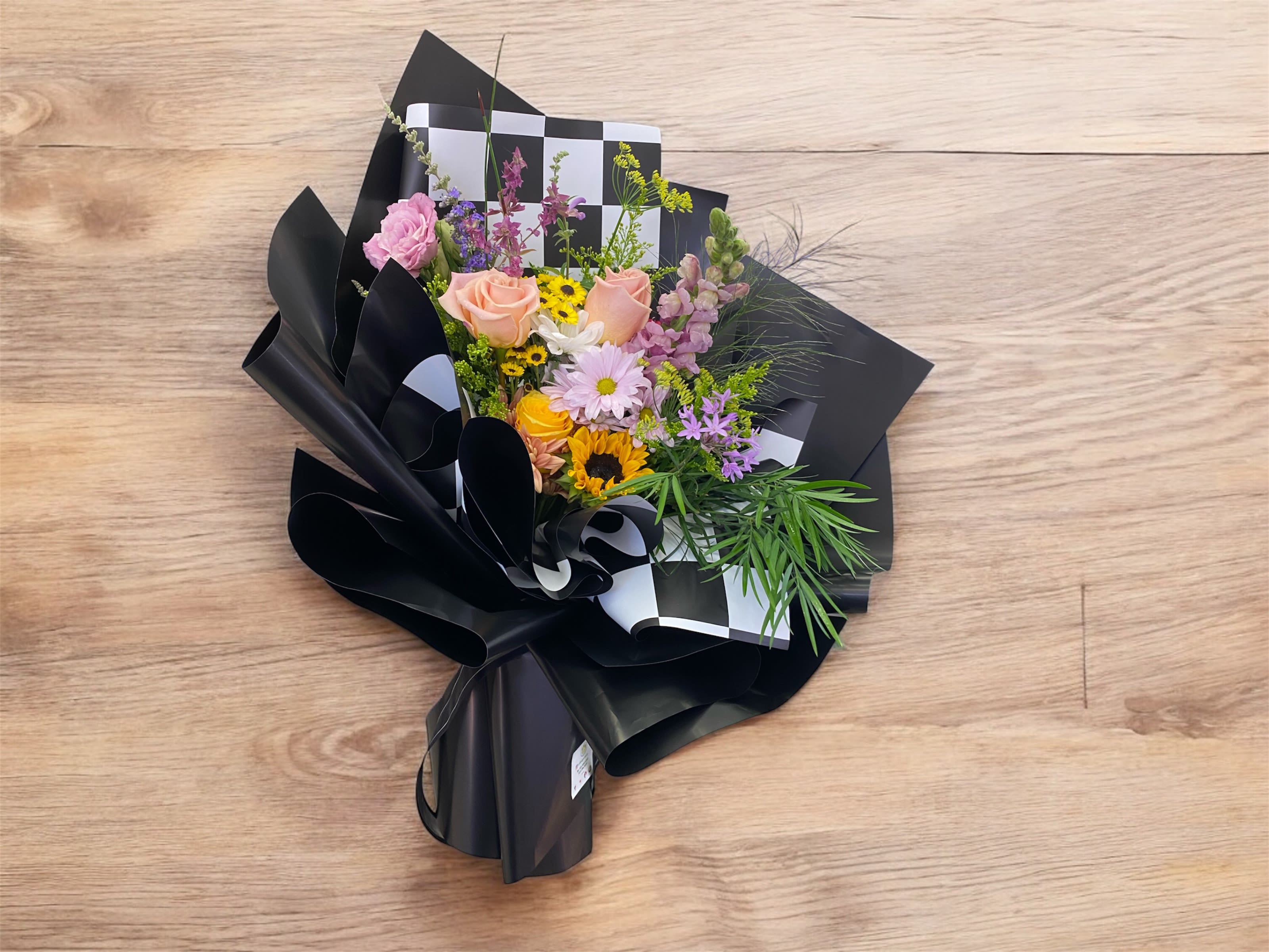 Black floral paper wrapped seasonal flower Black floral paper wrapped seasonal flower - Black floral paper wrapped seasonal flower