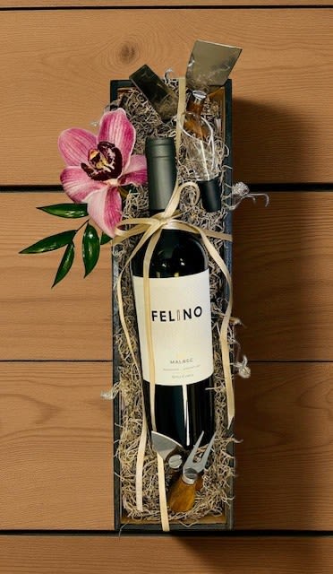 Cheers & Bloom Box Set Malbec Cheers & Bloom Box Set Malbec - Cheers & Bloom is an upscale gift box curated to impress. Housed in a sleek black wooden box, it features a bottle of rich Argentine Malbec, a wine aerator, artisan cheese tools, and a fresh orchid bloom. Elegant and refined, it’s the perfect way to celebrate, connect, or show appreciation in style. **To order wine from our catalog, both the customer and recipient must be at least 21 years old. Valid ID will be required upon delivery. By placing an order, you confirm that you and the recipient are of legal drinking age.