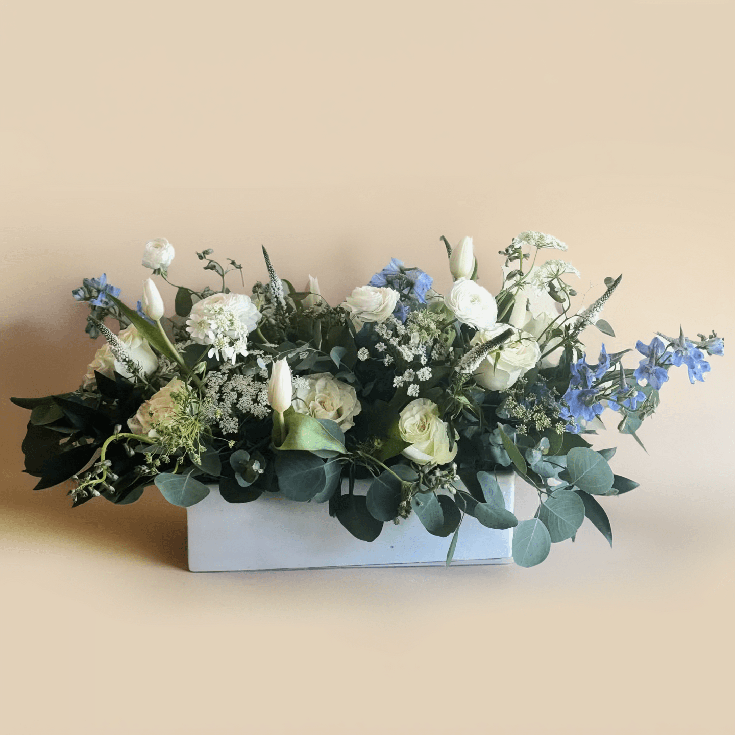 Cloud Nine Cloud Nine - Pastel floral compact design with light blue delphiniums, white roses and tulips