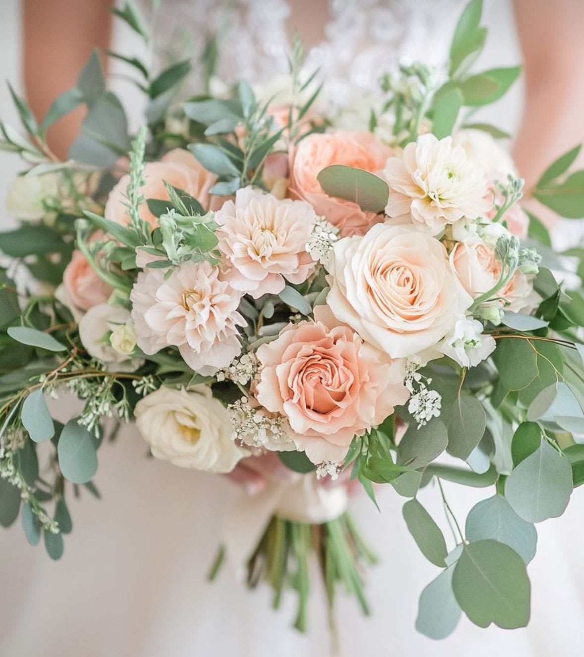 Apricot Kiss - With tender peach and blush roses, creamy dahlias, and airy eucalyptus, Apricot Kiss is a bouquet full of warmth, softness, and romantic charm. Its sun-kissed tones and graceful textures make it the perfect match for a bride who loves elegance with a whisper of whimsy.