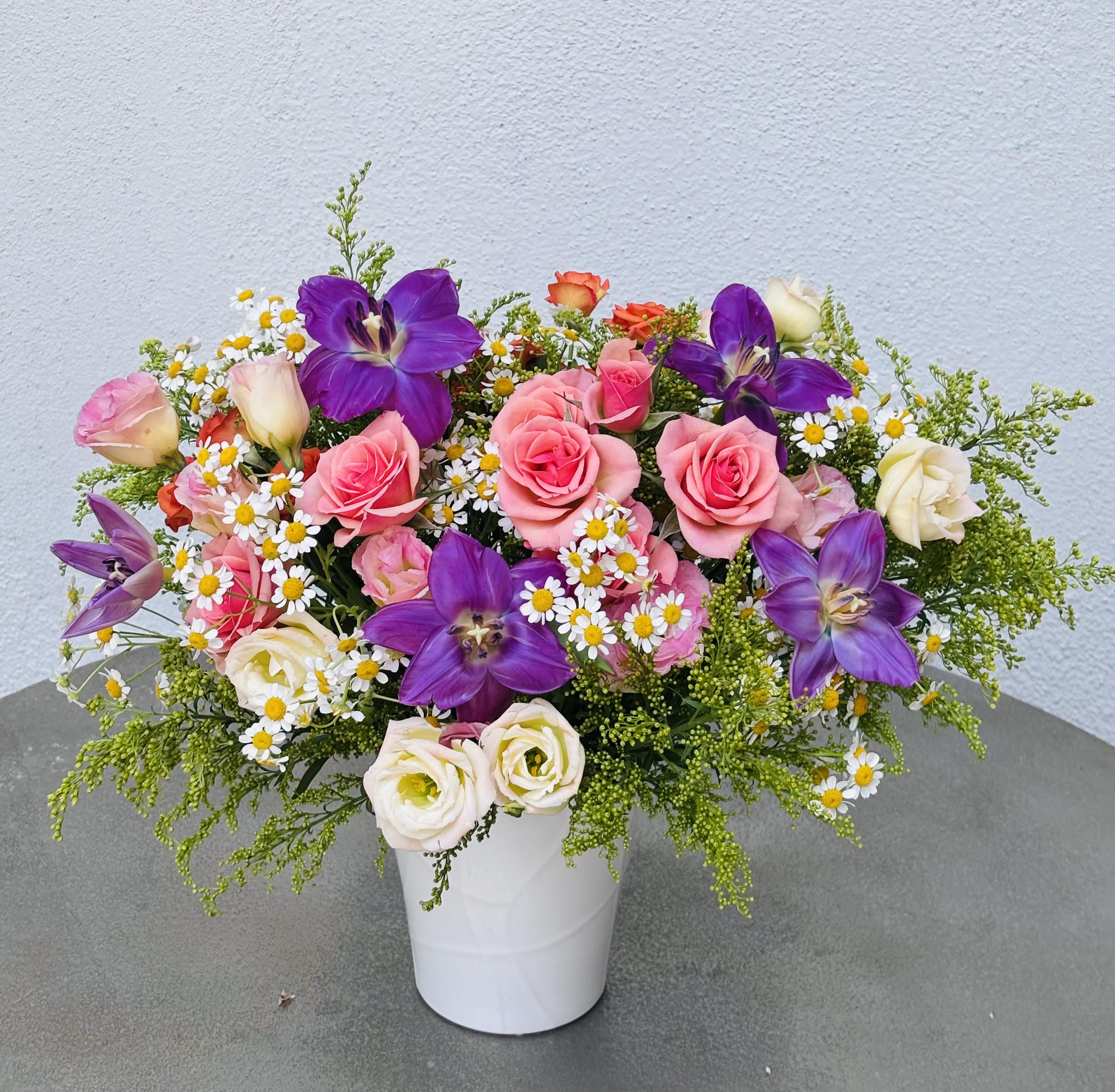 Violet Muse Violet Muse - A poetic blend of violet tulips, blush roses, chamomile, and creamy lisianthus, Violet Muse captivates with effortless elegance. Balancing soft romance with vivid charm, this arrangement is perfect for meaningful moments, heartfelt gifts, or simply celebrating beauty in full bloom.