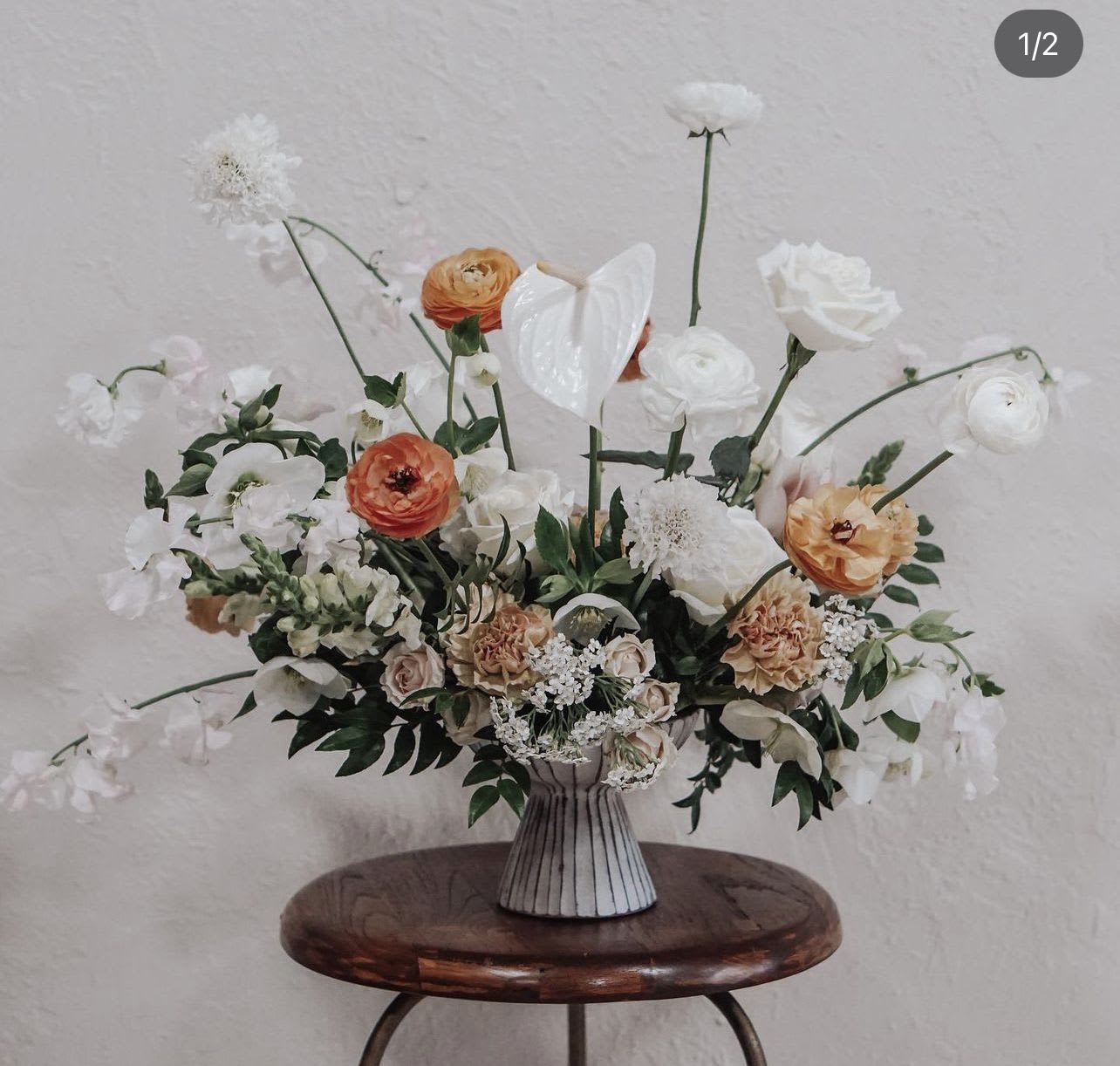 Creamsicle Creamsicle - The "Creamsicle" floral arrangement is a sweet and playful celebration of vibrant oranges and soft whites, evoking the nostalgic charm of a summer treat. With a mix of zesty citrus tones and creamy accents, this arrangement radiates warmth and joy. Its cheerful palette is perfect for bringing a lighthearted, fresh vibe to any space, making it ideal for birthdays, casual gatherings, or brightening up your home. "Creamsicle" is a delightful fusion of color and texture that captures the essence of sunny days and carefree moments. - Folsom CA florist