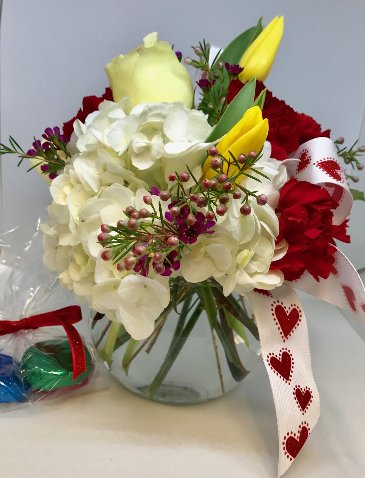Spring Time Valentine w/Euphoria Chocolate Covered Oreos Spring Time Valentine w/Euphoria Chocolate Covered Oreos - 6" Rose Bowl with some spring color for that Valentine that loves some yellow. Roses, Tulips, White Hydrangea with Red Carnations.
