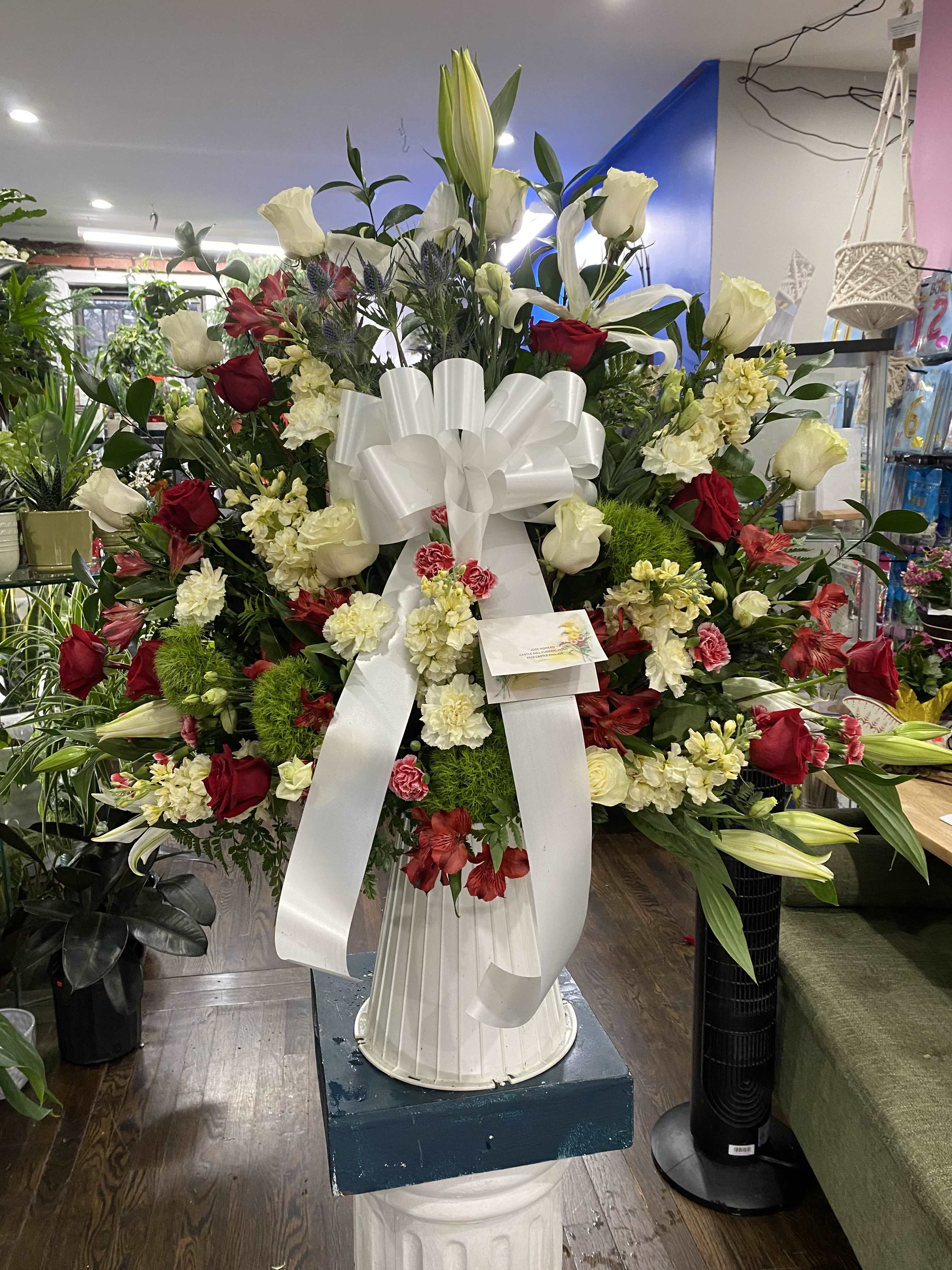 Lilies and Color Basket - This beautiful basket symbolizes peace and remembrance, with some colorful flowers to add a sense of gentle warmth to the overall arrangement. 
