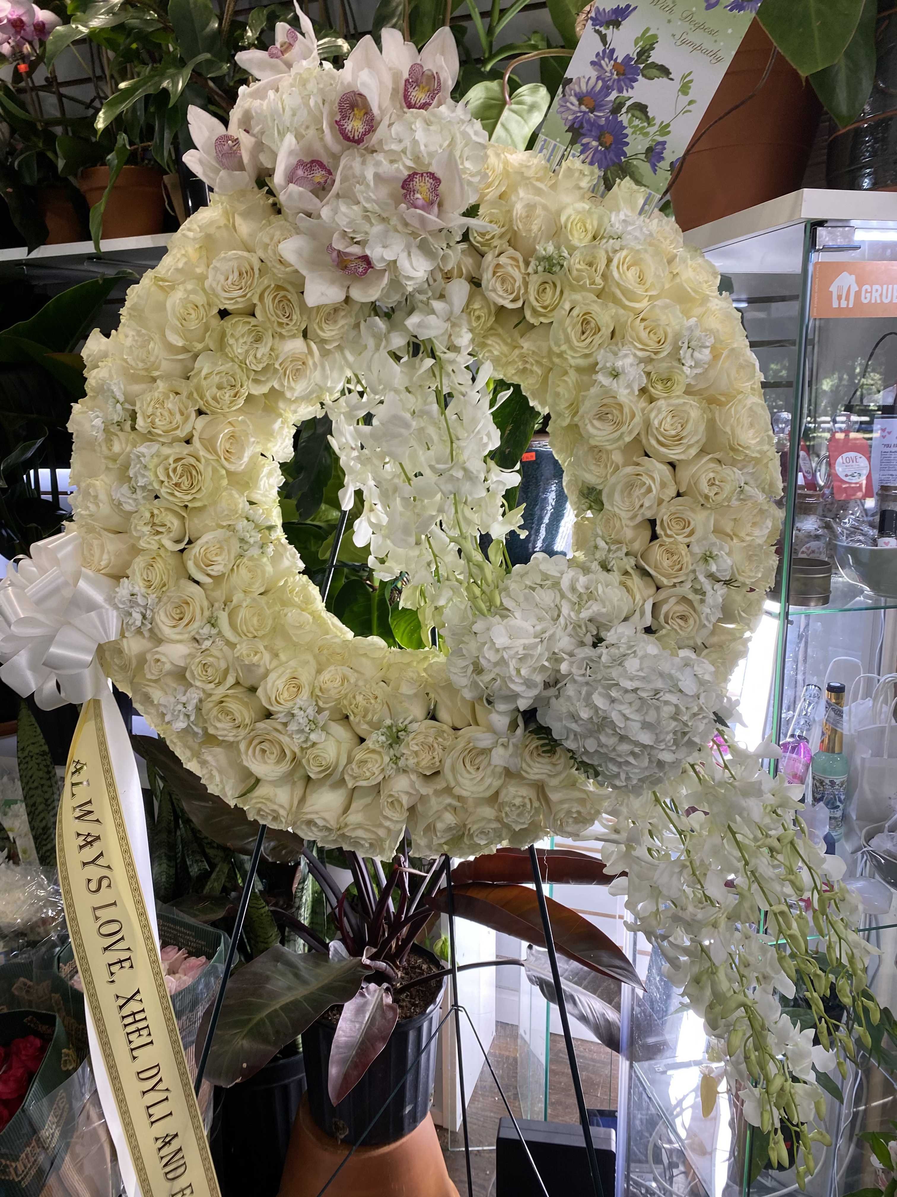 Orchid Wreath - This elegant funeral arrangement symbolizes eternal love, refined grace, and cherished memory. 