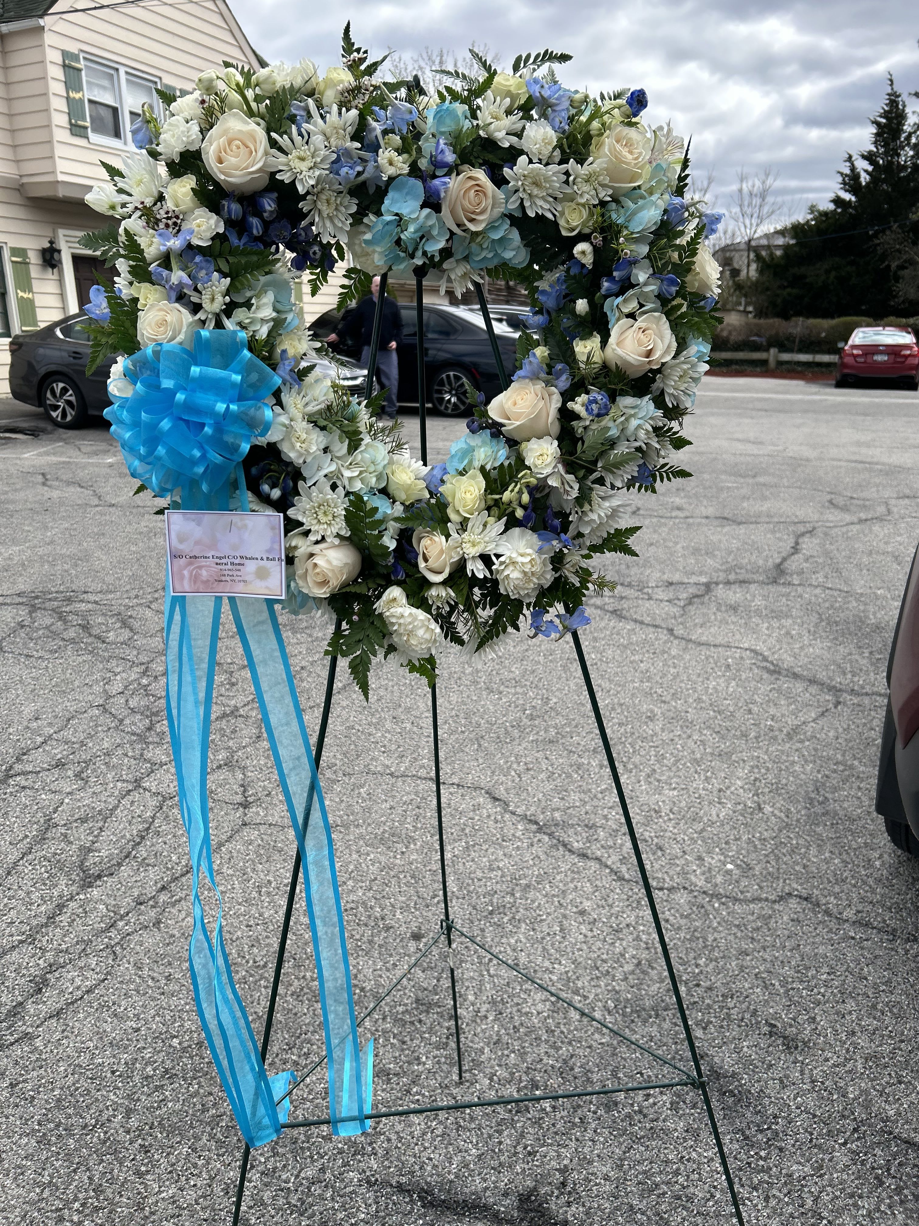 Goodbye For Him - This funeral arrangement is a distinguished and heartfelt tribute, designed to honor the life and memory of a beloved man. This arrangement symbolizes strength and enduring remembrance.  
