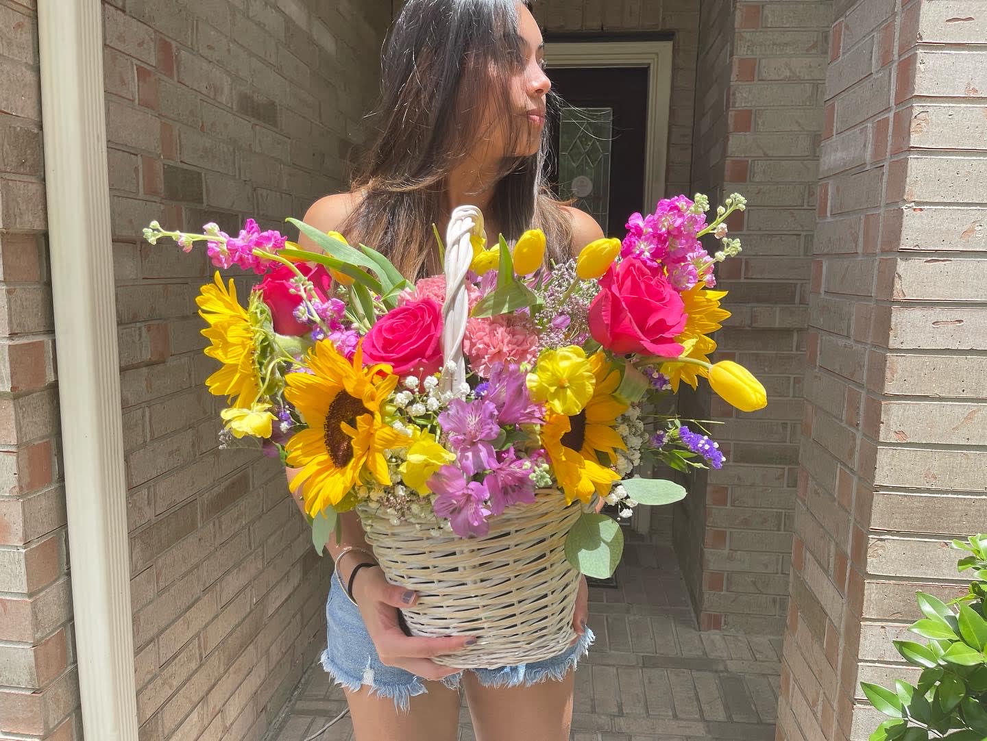 Adeline Basket - Inspired by bright nature and soft textures, this arrangement will wow your loved ones with its mix of roses, sunflowers  and seasonal flowers and foliage in  a woven basket.