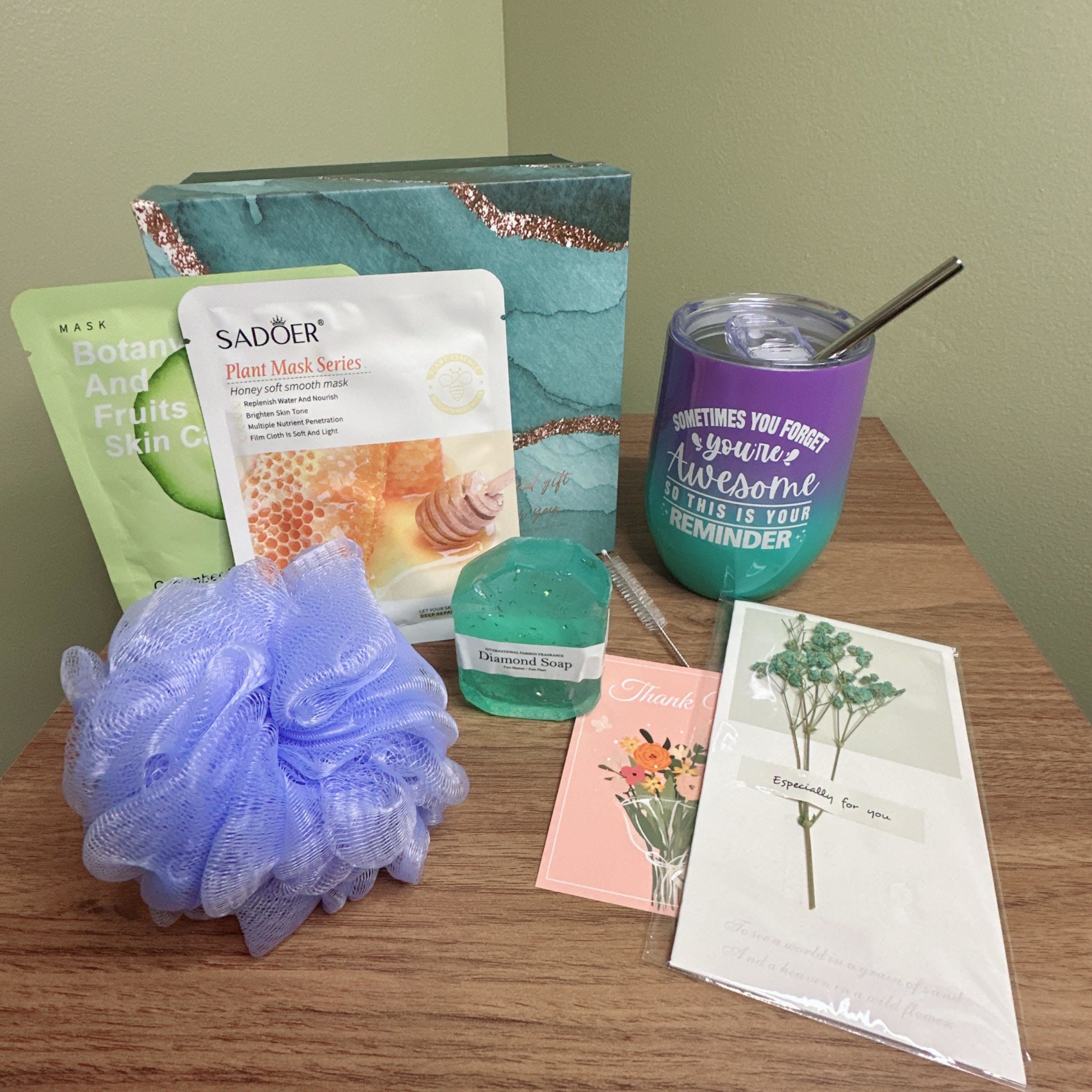 Self-Care Gift Set - Treat yourself or a loved one to a relaxing self-care experience with our thoughtfully curated gift set. This package includes:  - Two soothing face masks from the SADOER Plant Mask Series and Botanical Fruits Skin Care line - A gentle purple loofah for exfoliating and cleansing - A refreshing bar of Diamond Soap - A vibrant purple and teal tumbler with an inspiring message: &quot;Sometimes you forget you're awesome so this is your reminder&quot; - Two heartfelt greeting cards to express appreciation and gratitude  Perfect for anyone looking to unwind and pamper themselves, this gift set is ideal for birthdays, holidays, or simply as a gesture of kindness. 