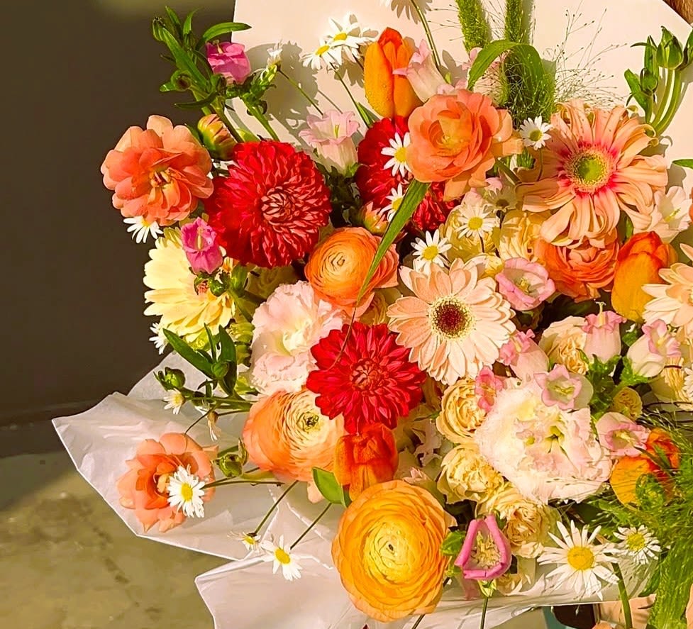 Hand Tied Bouquet - Custom mixed bouquets are wrapped in kraft paper or color plastic paper and ready to be used in a vase at home! The designer will personally select the flowers that are in season.