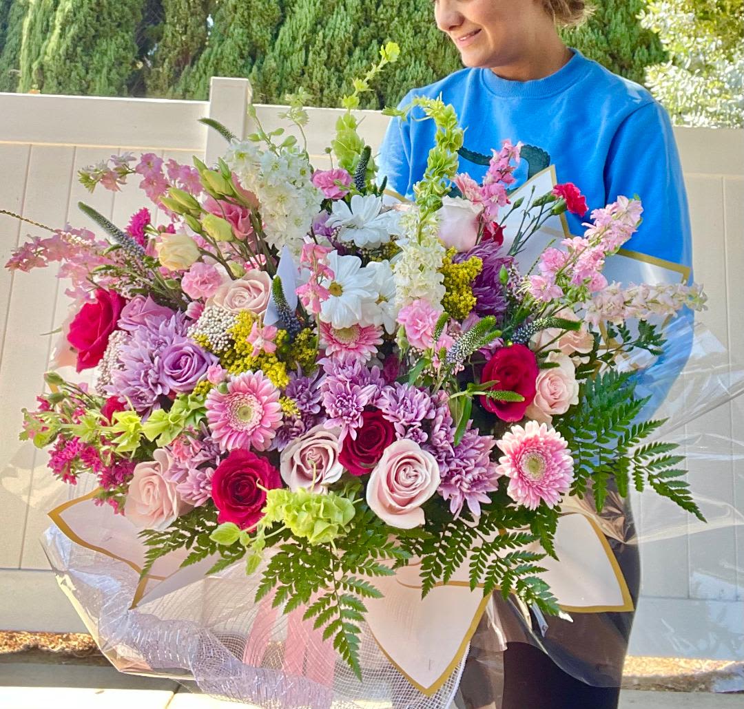 Season bouquet - Theme Colors: colorful.  Featured Blooms: flower of season bouquet.    HK Flowers have a uniqueness of florals and seasonal blooms, certain flowers or colors may not be available as each season affects the availability, color, size, and shape of each floral bloom. Some flowers may be substituted accordingly.  Photos are used as a reference for the color palette and is NOT indicated of the final product. We ask for your trust in us that we will pick out the best seasonal available blooms, while still capturing the arrangements' theme and colors mentioned above.