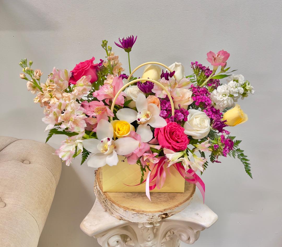 Citrus sunshine Citrus sunshine - Theme Colors: Shades of purples, pink, Yellow Featured Blooms: Roses, orchid, stock, Chrysanthemums, Alstroemeria, with Seasonal Blooms, in a bag. HK Flowers have a uniqueness of florals and seasonal blooms, certain flowers or colors may not be available as each season affects the availability, color, size, and shape of each floral bloom. Some flowers may be substituted accordingly. Photos are used as a reference for the color palette and is NOT indicated of the final product. We ask for your trust in us that we will pick out the best seasonal available blooms, while still capturing the arrangements' theme and colors mentioned above.