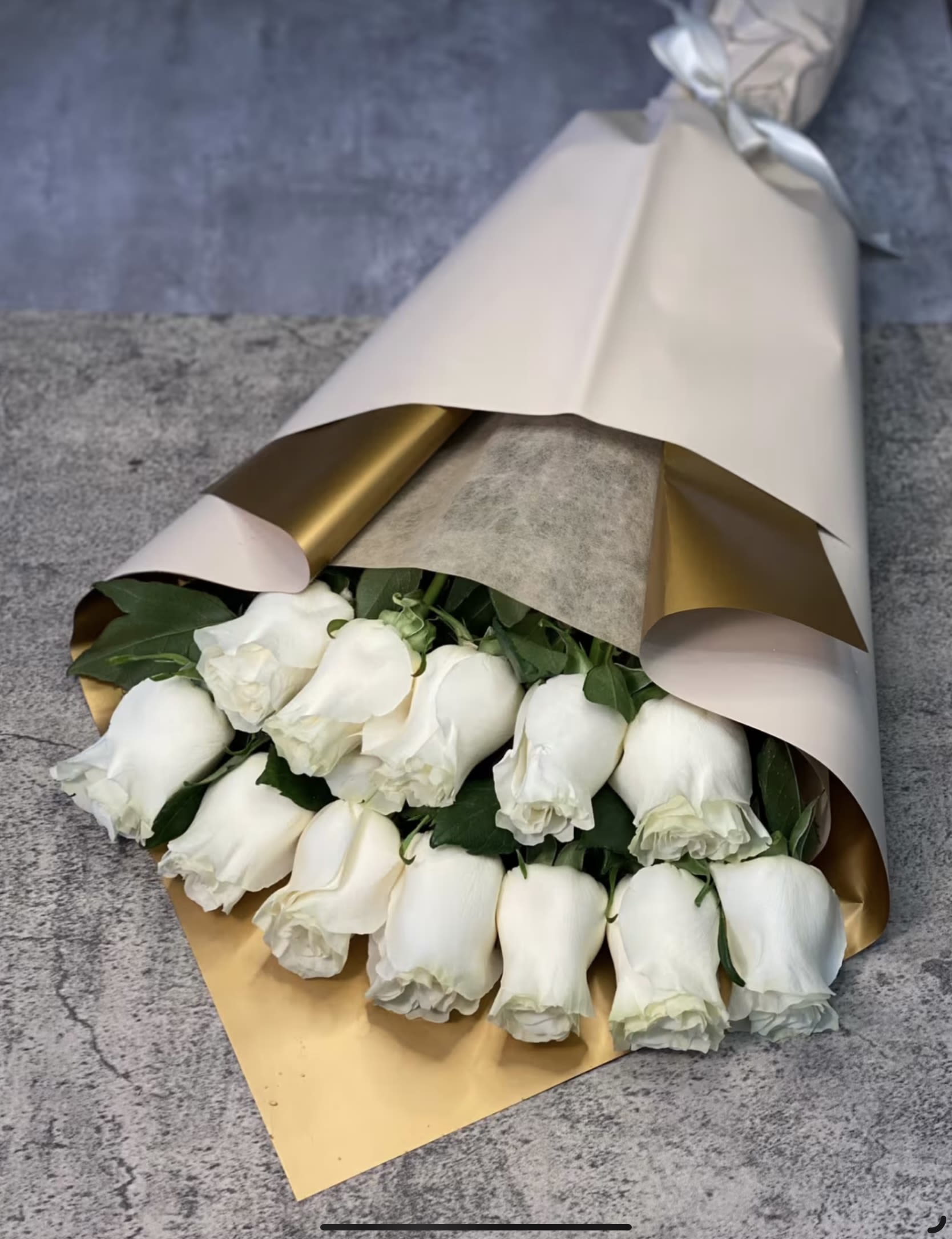 White Roses - Embrace elegance and purity with our White Roses Boutique – a timeless arrangement of fresh white roses, beautifully accented with lush greenery. Wrapped in soft, premium paper and tied with a delicate ribbon, this bouquet is perfect for weddings, anniversaries, or any occasion that calls for a touch of grace and sophistication. Order now to share the beauty and serenity of white roses with someone special!