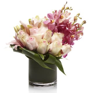 Pink Dream by Sophisticated Blooms - A pleasant contemporary arrangement featuring pink roses, lilies and orchids designed neatly in a premium glass vase.  • Pink Alstroemeria • Pink Roses • Pink Orchids • Glass Cube or Cylinder Vase • Personalized Gift Message • The premier luxury floral gifting experience