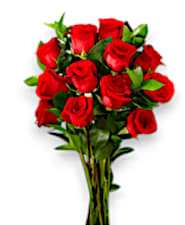 Wrapped Dozen Roses  - Twelve enchanting roses, embraced by lush greenery and elegantly wrapped in delicate paper, create a beautiful bouquet that speaks of romance. To elevate this gesture of love, a satin bow gently ties it all together, while a thoughtful packet of flower food rests alongside, ensuring your roses thrive as a symbol of your blossoming affection.