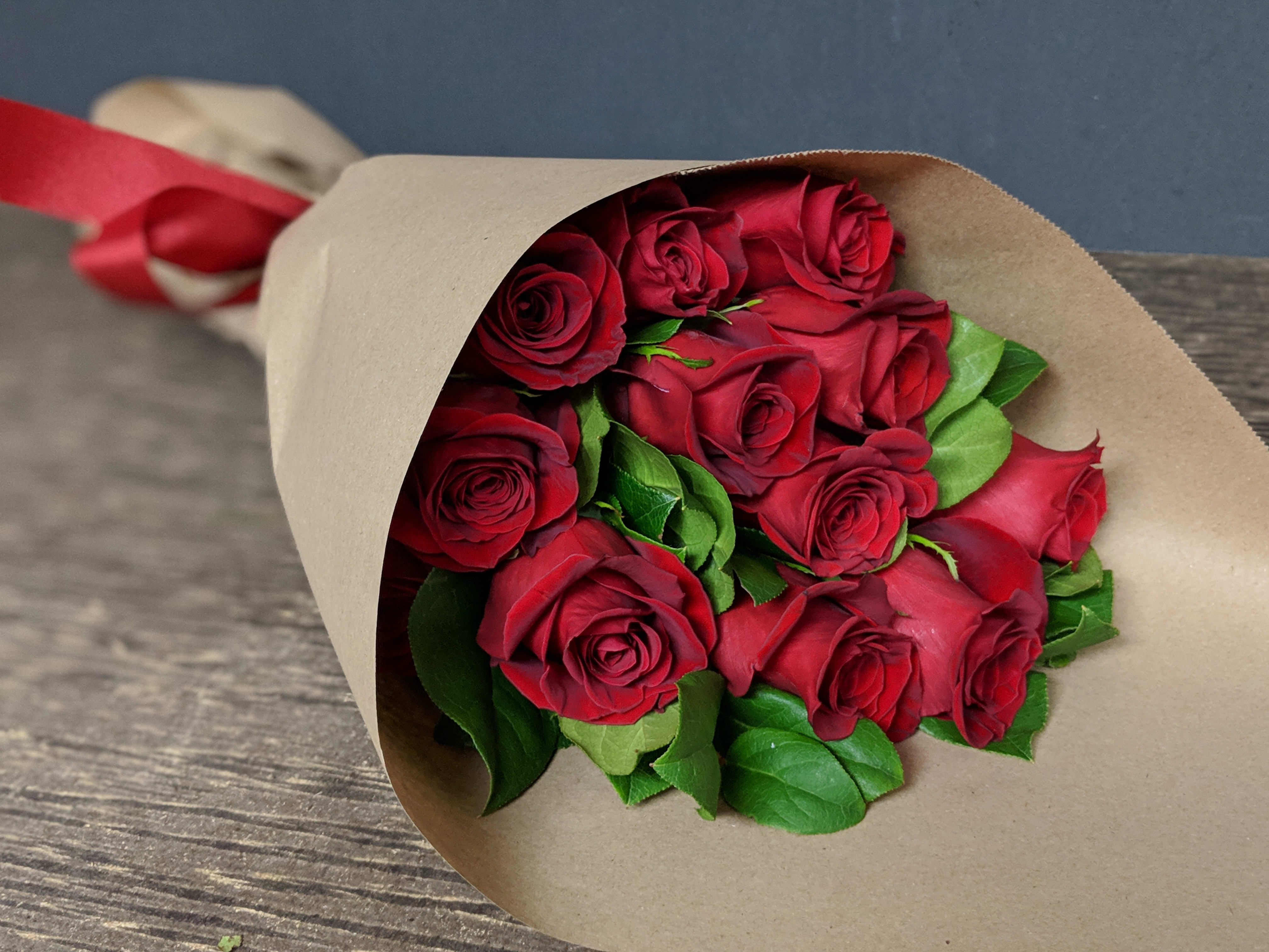 Long Stem Wrapped Red Roses  - One dozen long stem red roses hand wrapped in brown paper. This elegant hand wrap makes anyone feel the love!  **NOT IN WATER** Once received by recipient, Cut stems to desired length and place flowers in water.   *** Based on quality and /or availability of flowers, our fillers may be substituted to equal or greater value made at designers discretion, we do this for quality and availability****  THE ARRANGEMENT THAT WILL BE PICKED UP WILL LOOK DIFFERENT FROM THE PHOTO SHOWN