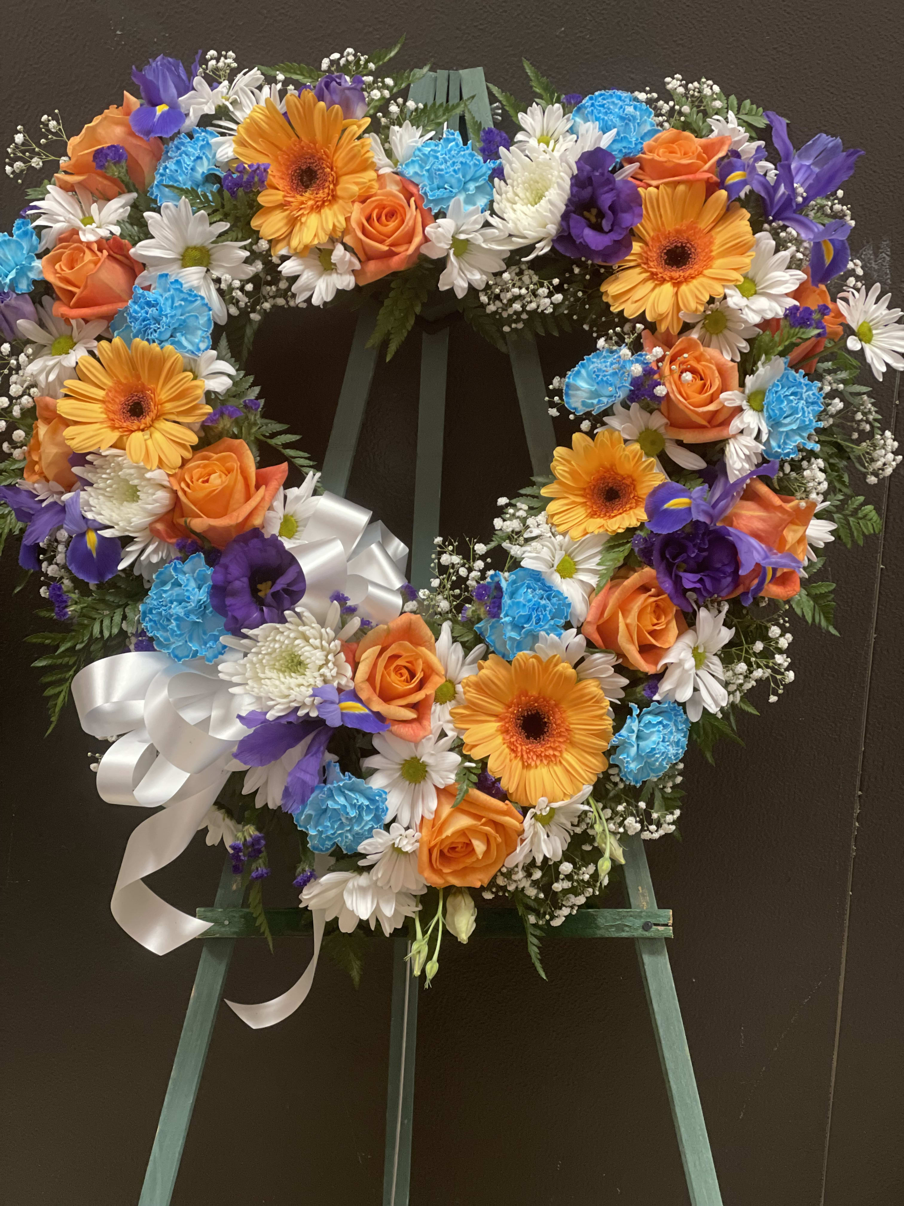 Blue and peach standing Heart (FH20) Blue and peach standing Heart (FH20) - This Beautiful made with Blue carnation, peach roses and gerbera daisy , dark blue lisanthus, white daisy, and finish with baby breath. .