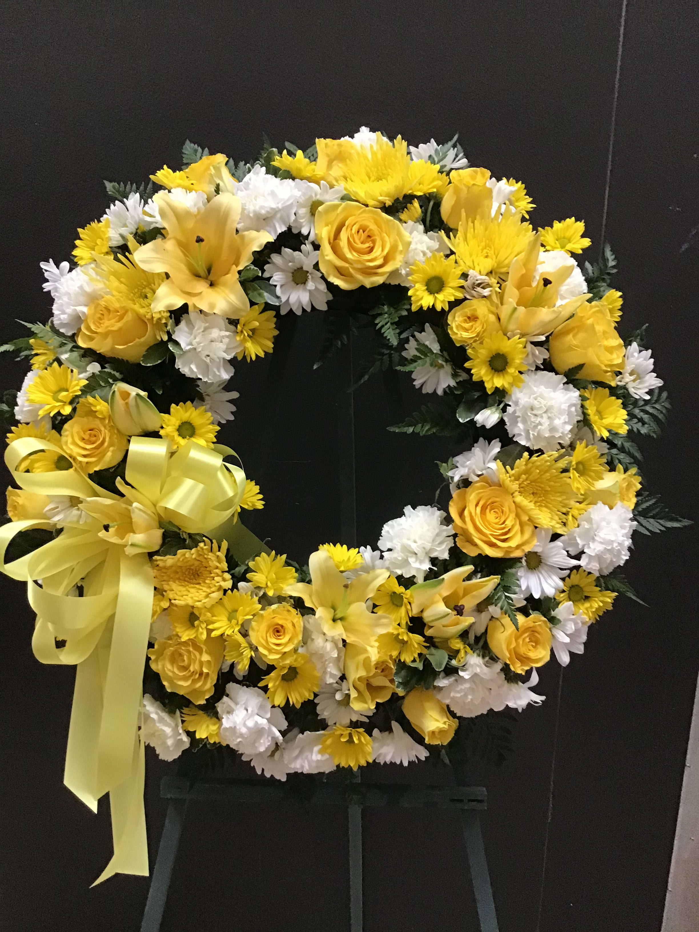 Yellow and white wreath (FW19) Yellow and white wreath (FW19) - This wreath make with yellow roses, lilies daisies, and white carnatiions