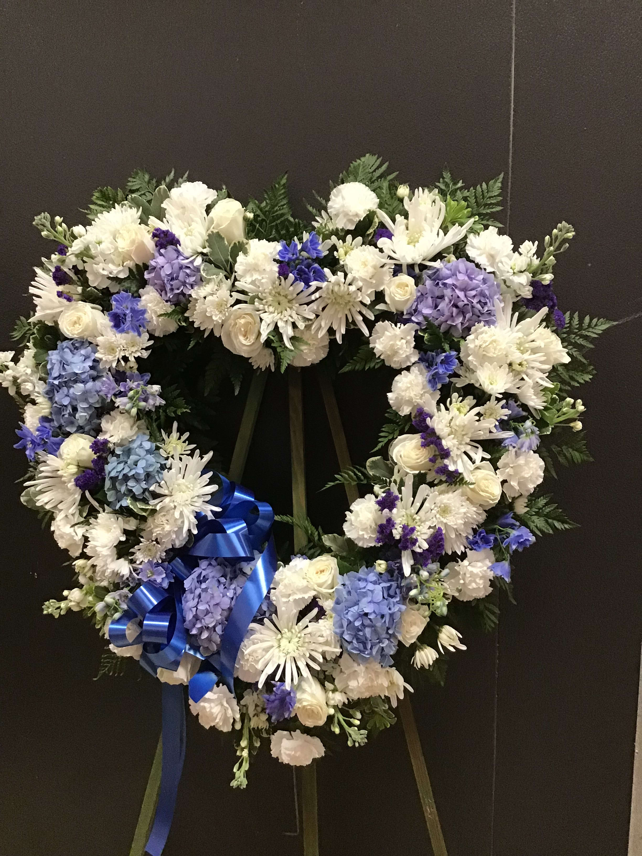 Blue and White Open Heart FH17 Blue and White Open Heart FH17 - This open heart make with white roses, spider mum and carnations, blue hydrangea and bella donna