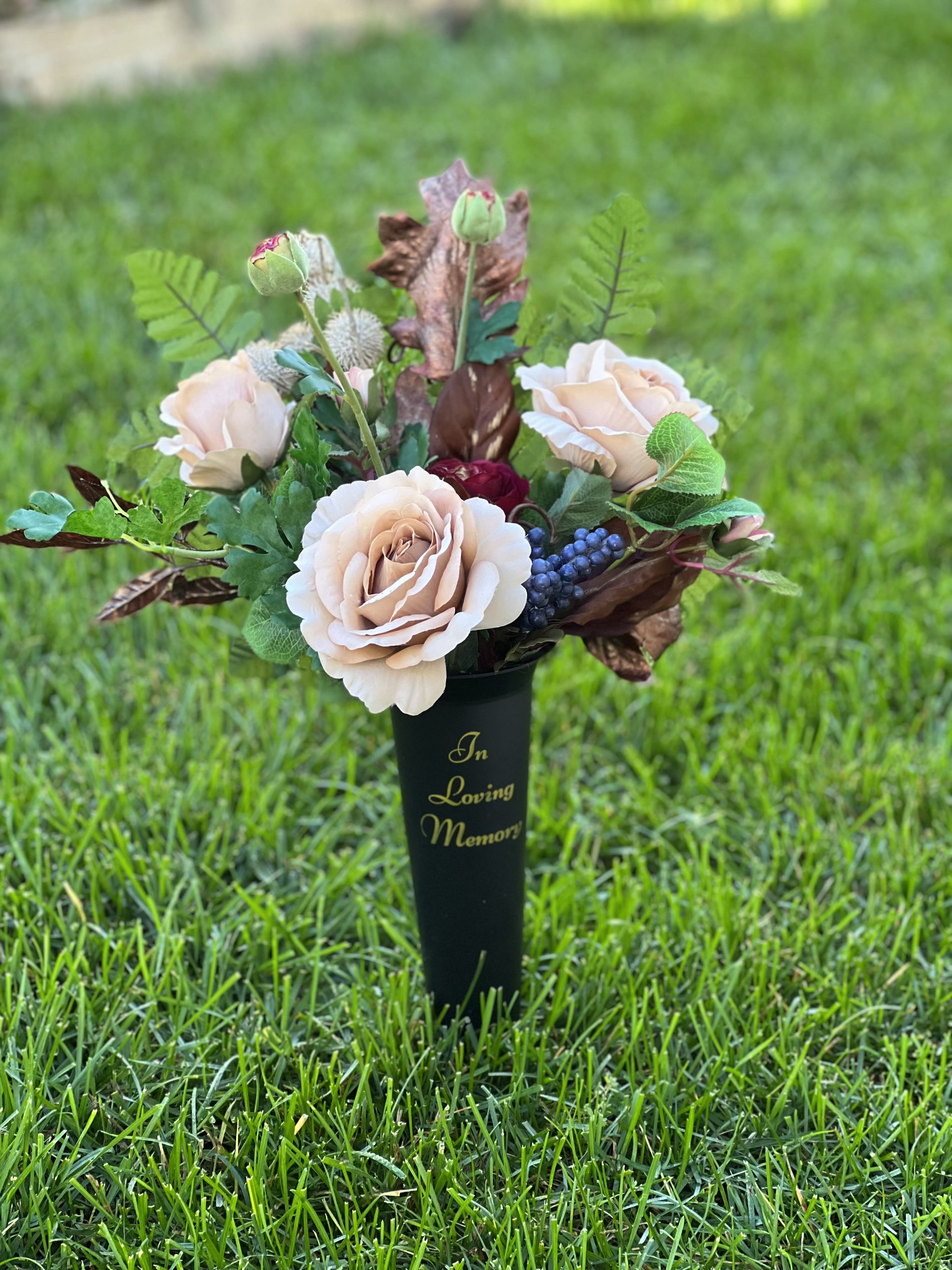 Summer Rose Cemetery Vase Summer Rose Cemetery Vase - Our Summer Rose cemetery vase is filled with wonderful blend of silk flowers for your placement graveside. Firmly nestled into a sleek black vase with attached pick to place into the ground.