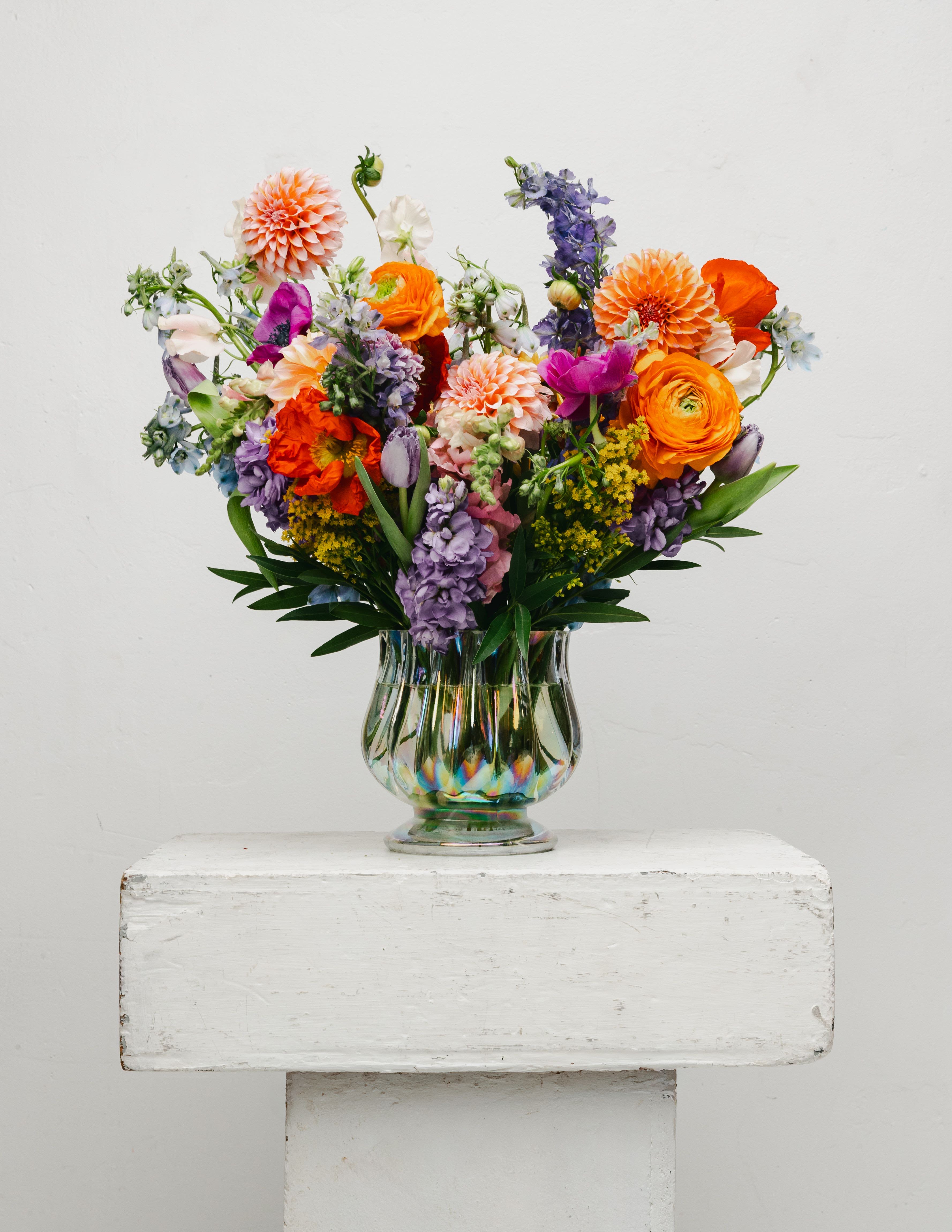 Seasonal Vased Arrangement  - Each of our arrangements is a one-of-a-kind creation, thoughtfully designed using the freshest flowers sourced directly from the flower market each morning. Because our designs are always inspired by what’s in season, every arangement is unique and beautifully reflects the changing seasons, offering something fresh and special every time. If you have any specific flowers in mind or inspiration please let us know! We’re happy to tailor each arrangement to your preferences for a truly personalized touch.  