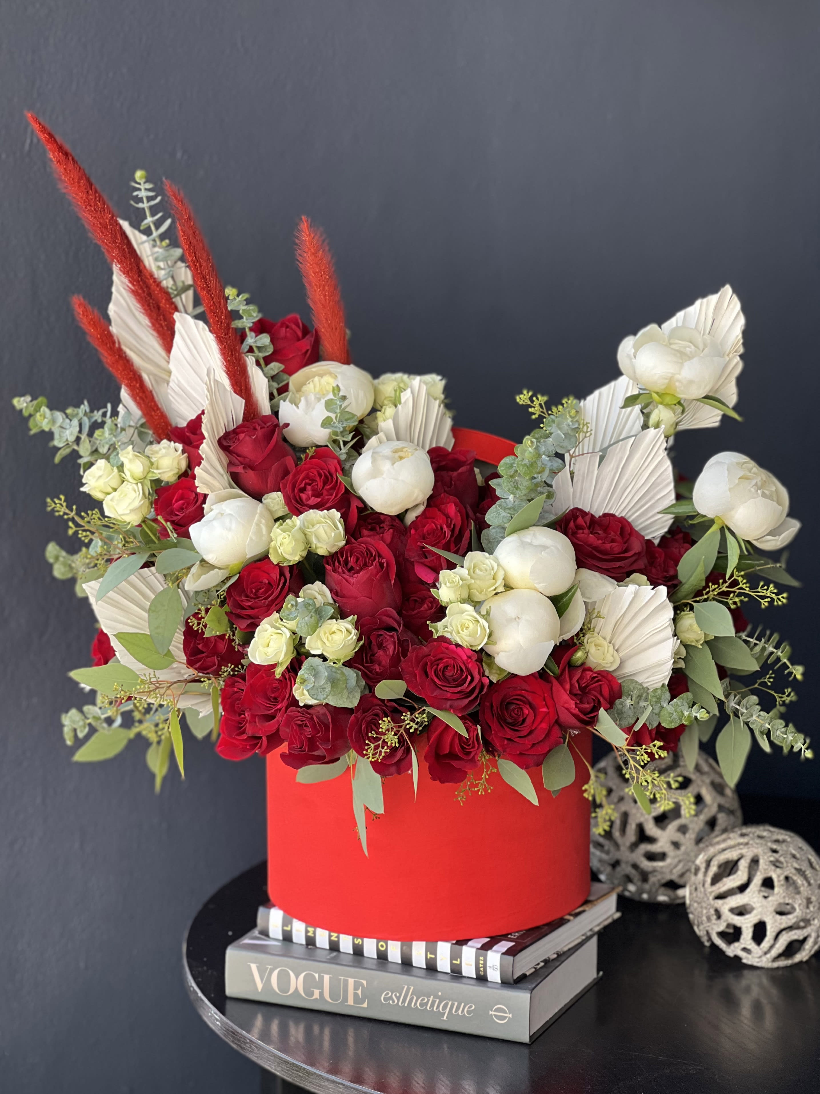 A classic Romance  - Boxed design in red and white colors. with roses, spray roses and peonies with dry leaves accent.  Show your love with this beautiful arrangement  