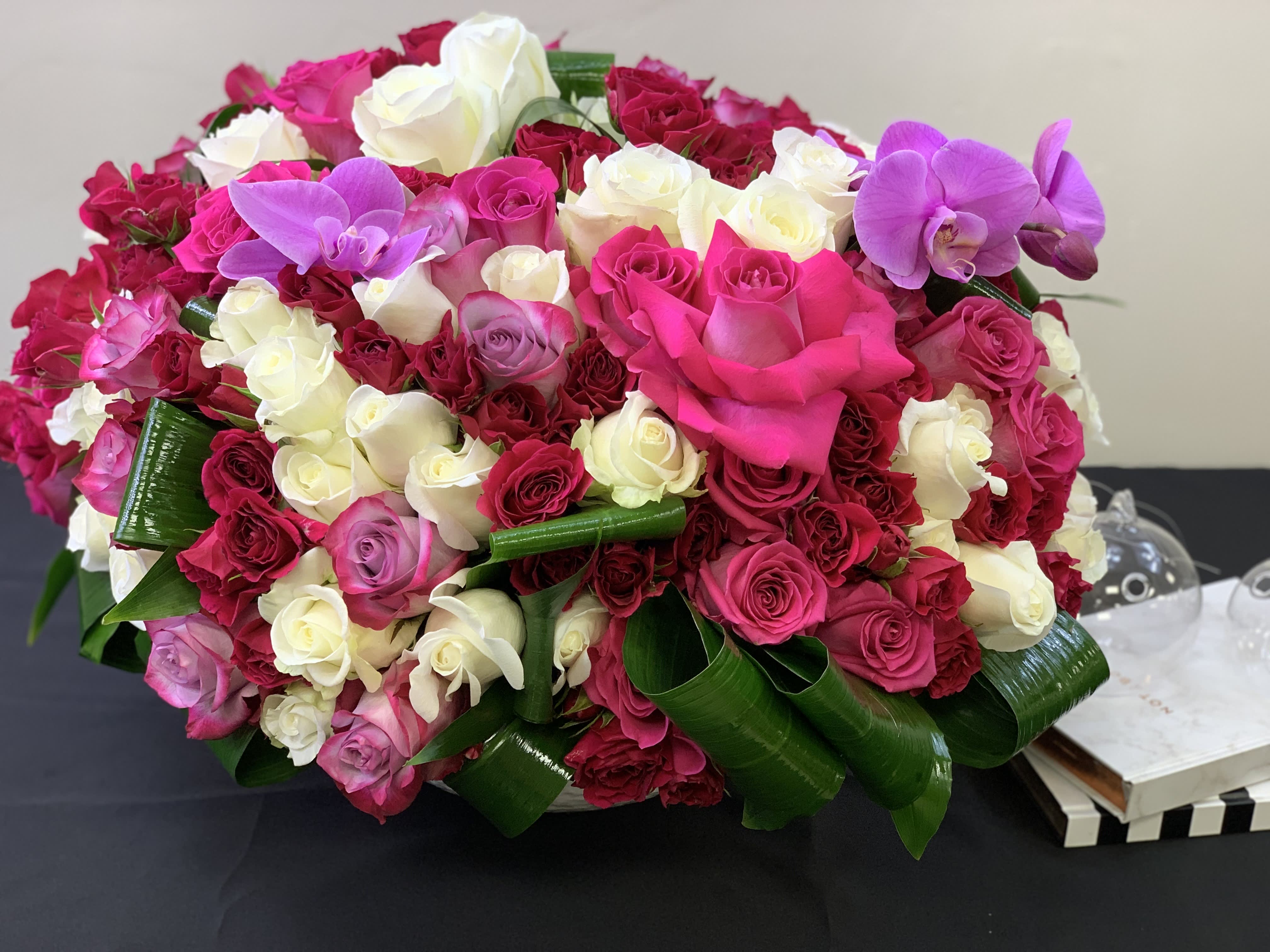 Blooming Romance  - Blooming Romance | Mixed roses in ceramic vase  Ceramic vase with mixed color roses  Includes up to 125-150 roses and Phalaenopsis orchids with greenery accent.  Size: large