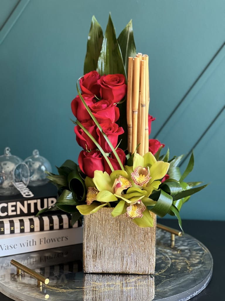 Modern Roses - Dozen red roses and cymbidium orchids in gold vase 