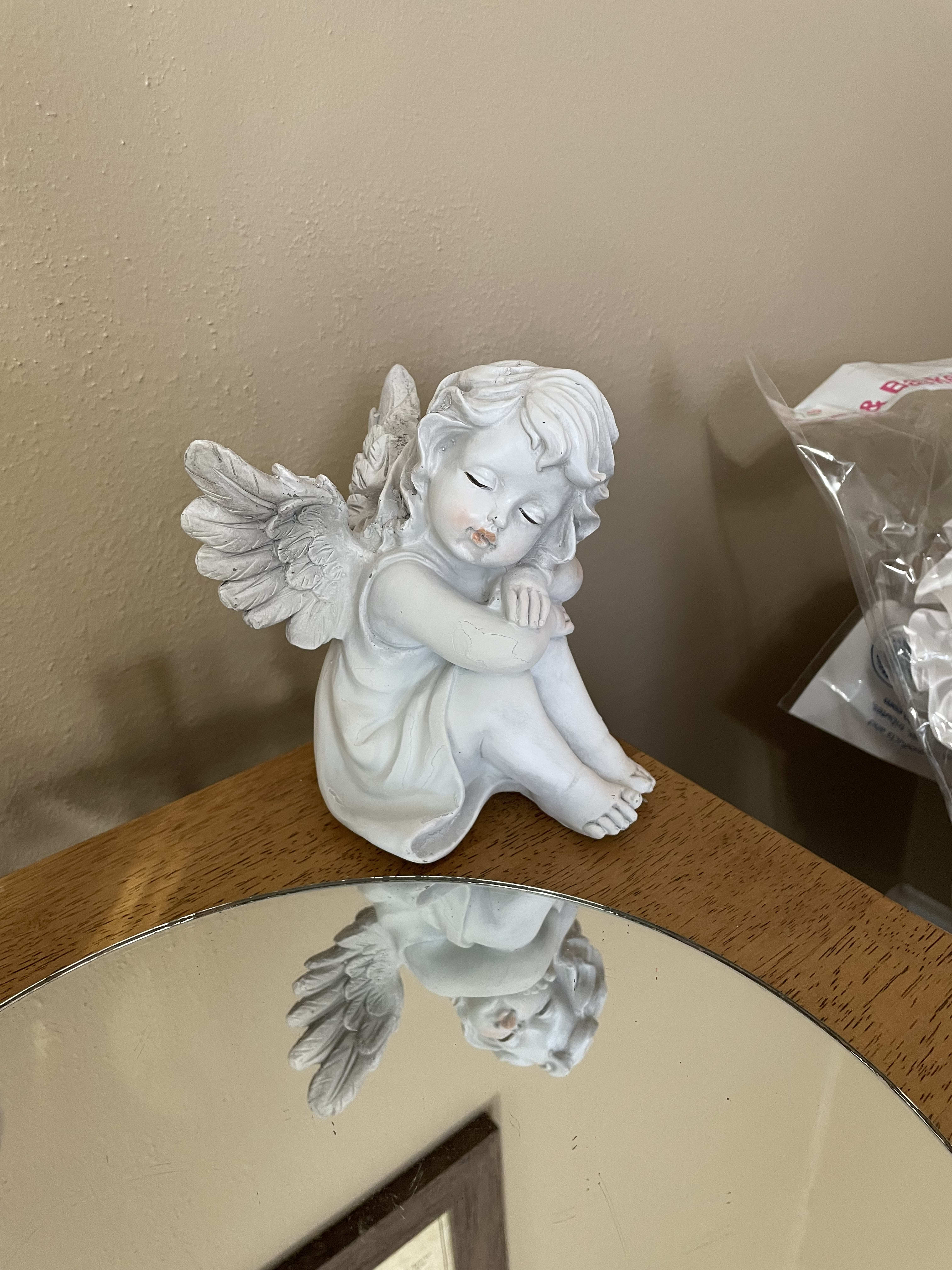 Praying Wings Angel Girl Praying Wings Angel Girl - White resin wood carved angel figurine. Wrapped for home. Bows for services. Approximately Dimensions: 6" W x 5.75" L
