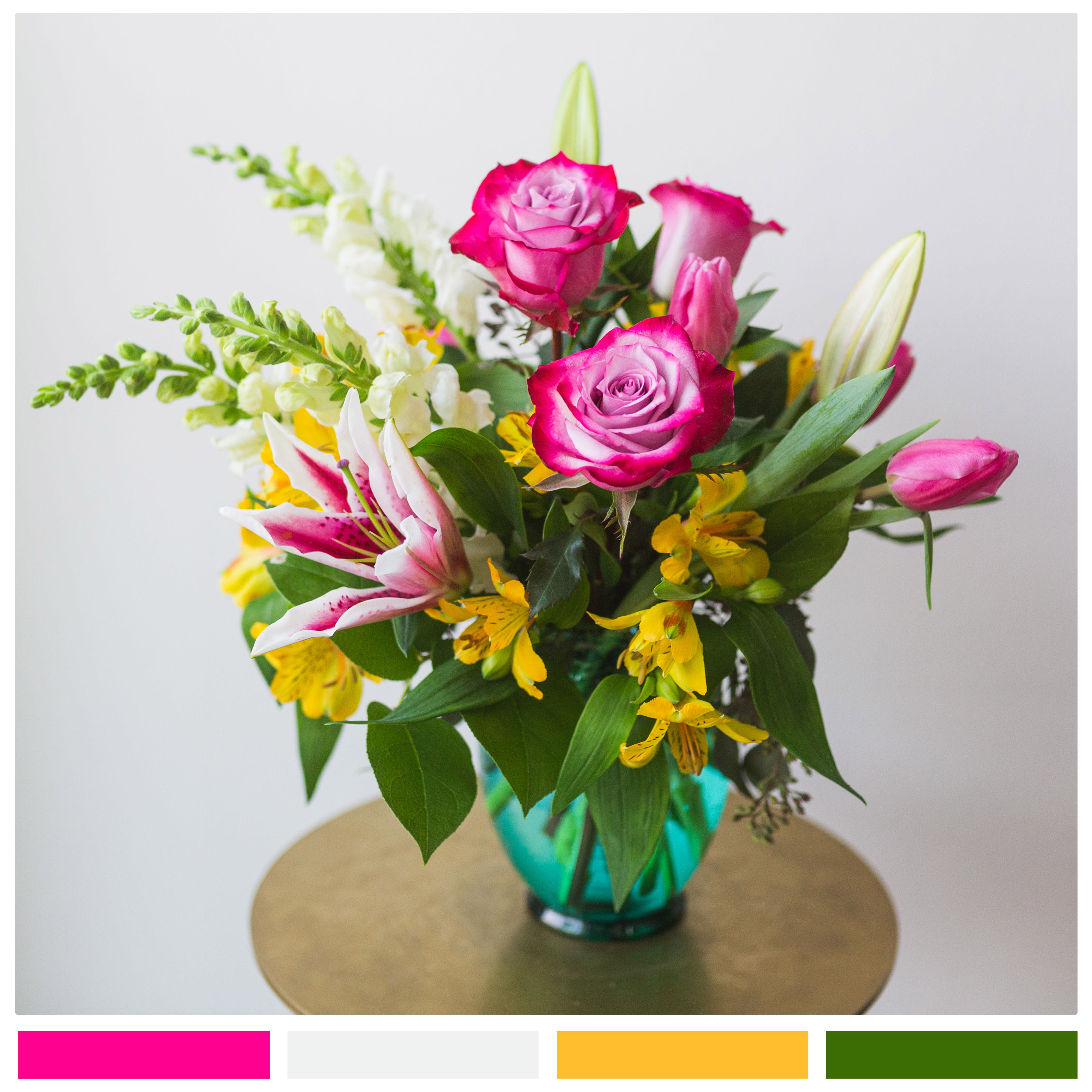 Spring Magic - A delightful mixture spring colors, this arrangement is certain to put a smile on the face of the recipient.  Includes stargazer lilies, roses, and seasonal beauties presented in a low round vase. Welcome spring with this blooming beauty!