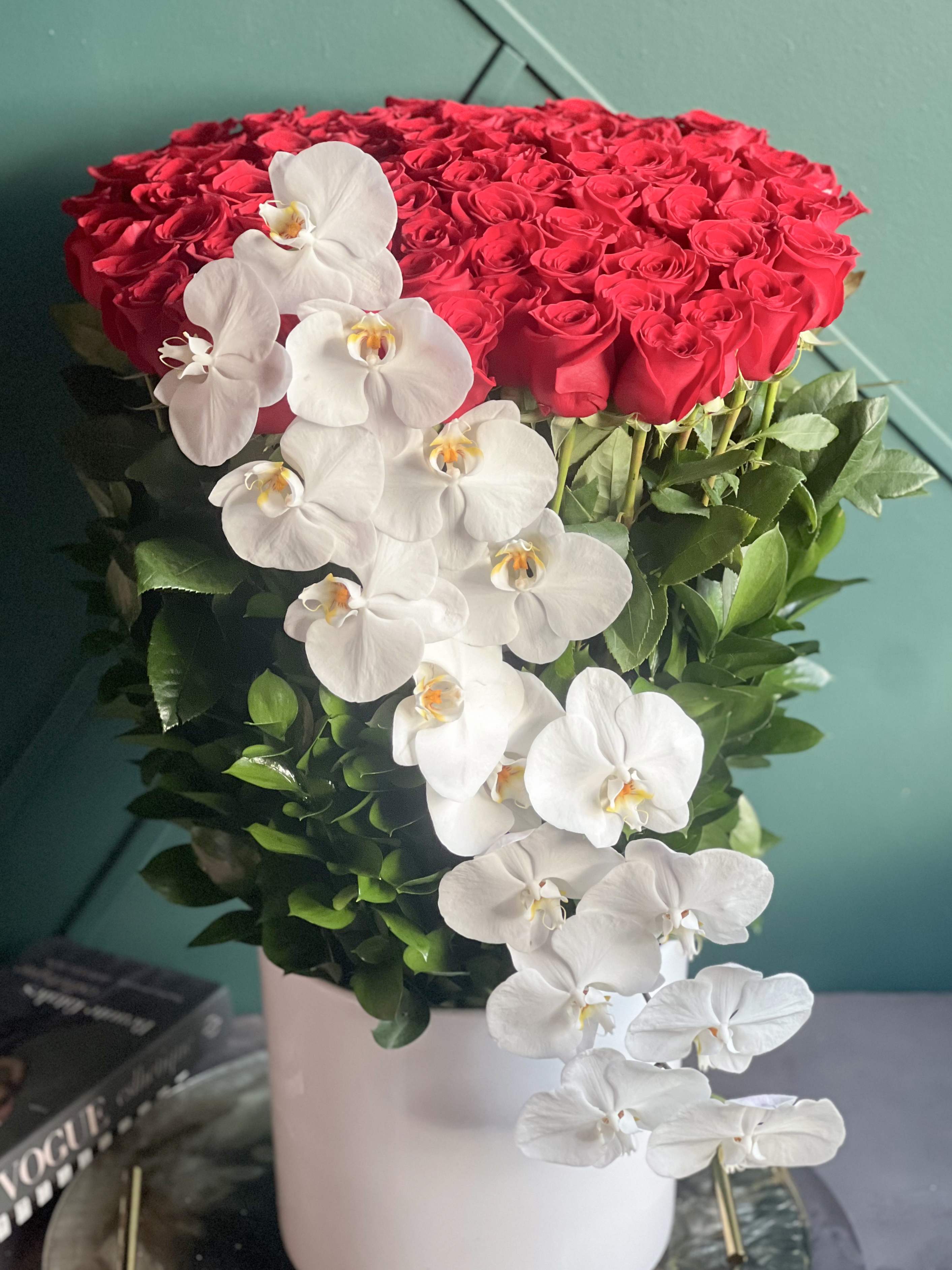 100 Long Stem Red roses in ceramic vase. - 100 Long Stem Red roses in ceramic vase.  Product Details:  Luxury, tall design with 100 long stem roses in ceramic vase with perfect phalaenopsis line  Approximately 2,5 feet tall and 20&quot; inch wide