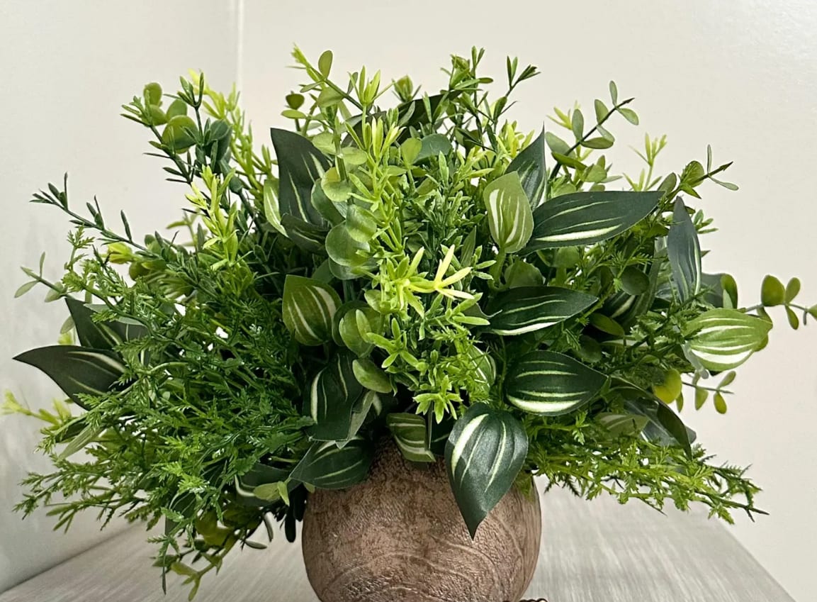 Greenery Arrangement - The greenery composition is designed with faux plants and assorted faux greenery in a faux driftwood style planter.