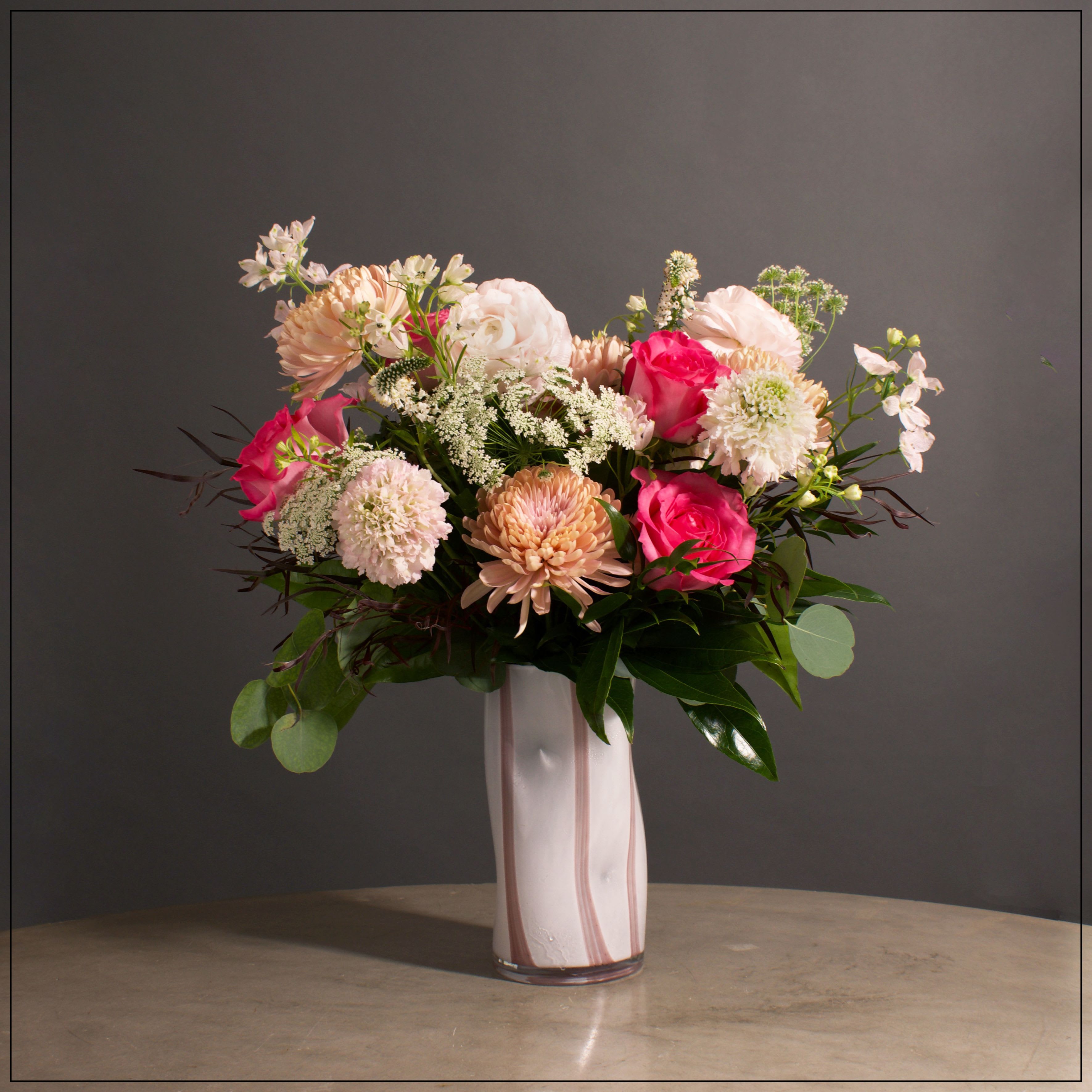 Georgina - White and pink stripe art glass vase filled with cremons, rose, scabiosa, ranunculus, delphinium, veronica, and Queen Anne's Lace. Approximately 19&quot; tall and 19&quot; wide